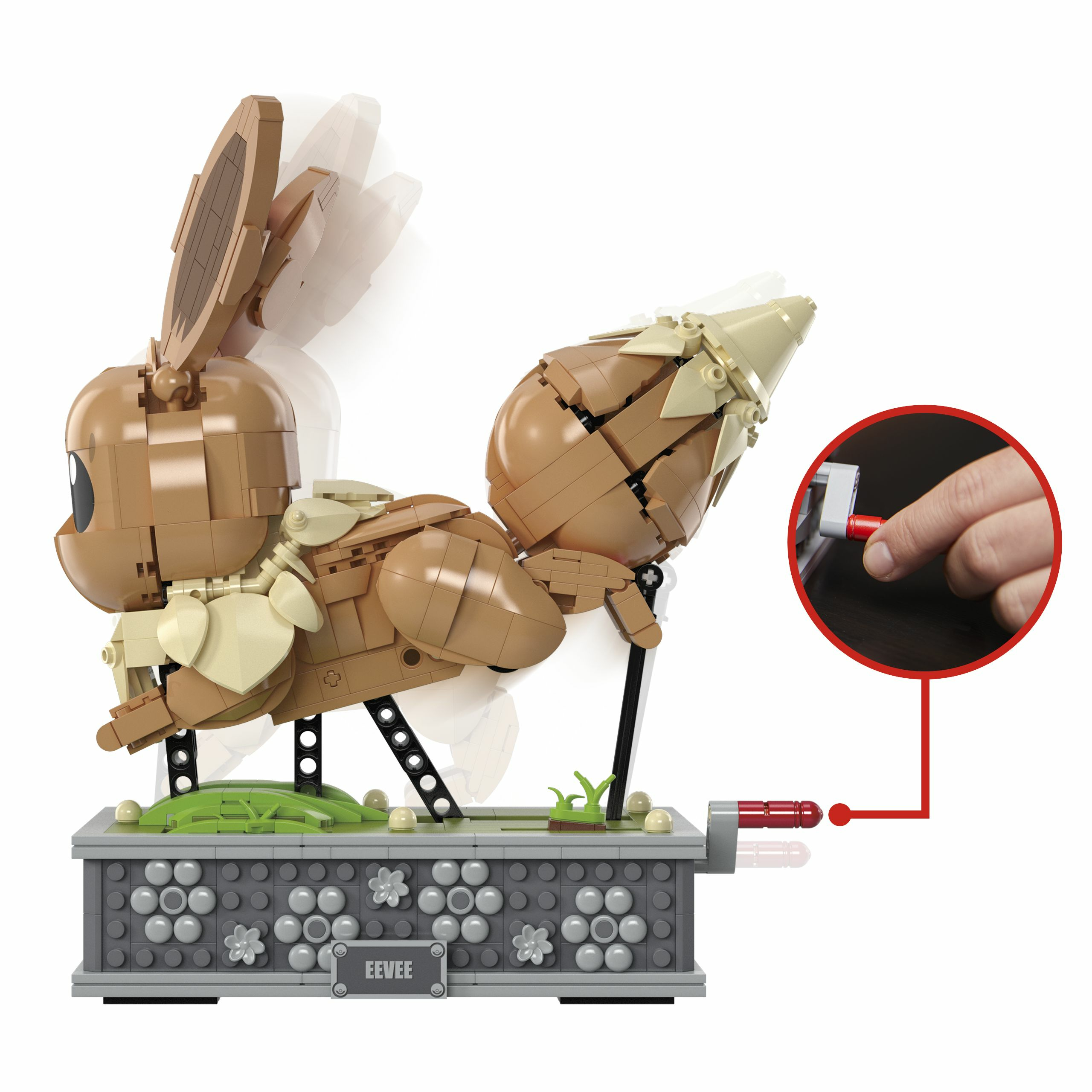 Un modello Lego di Eevee, con una manovella rossa girata da una mano.