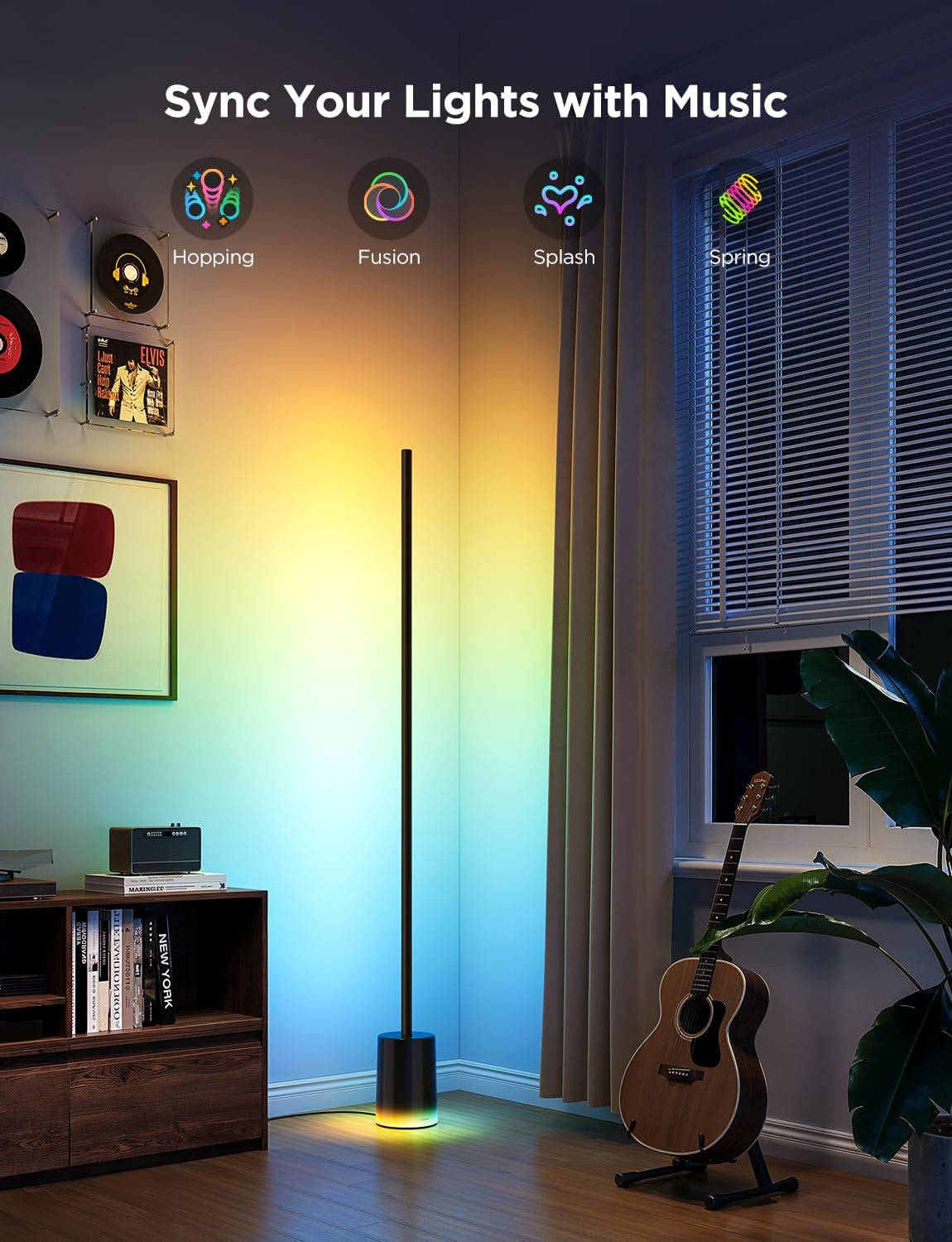 Room with a color-changing floor lamp, guitar, and framed art on the wall.