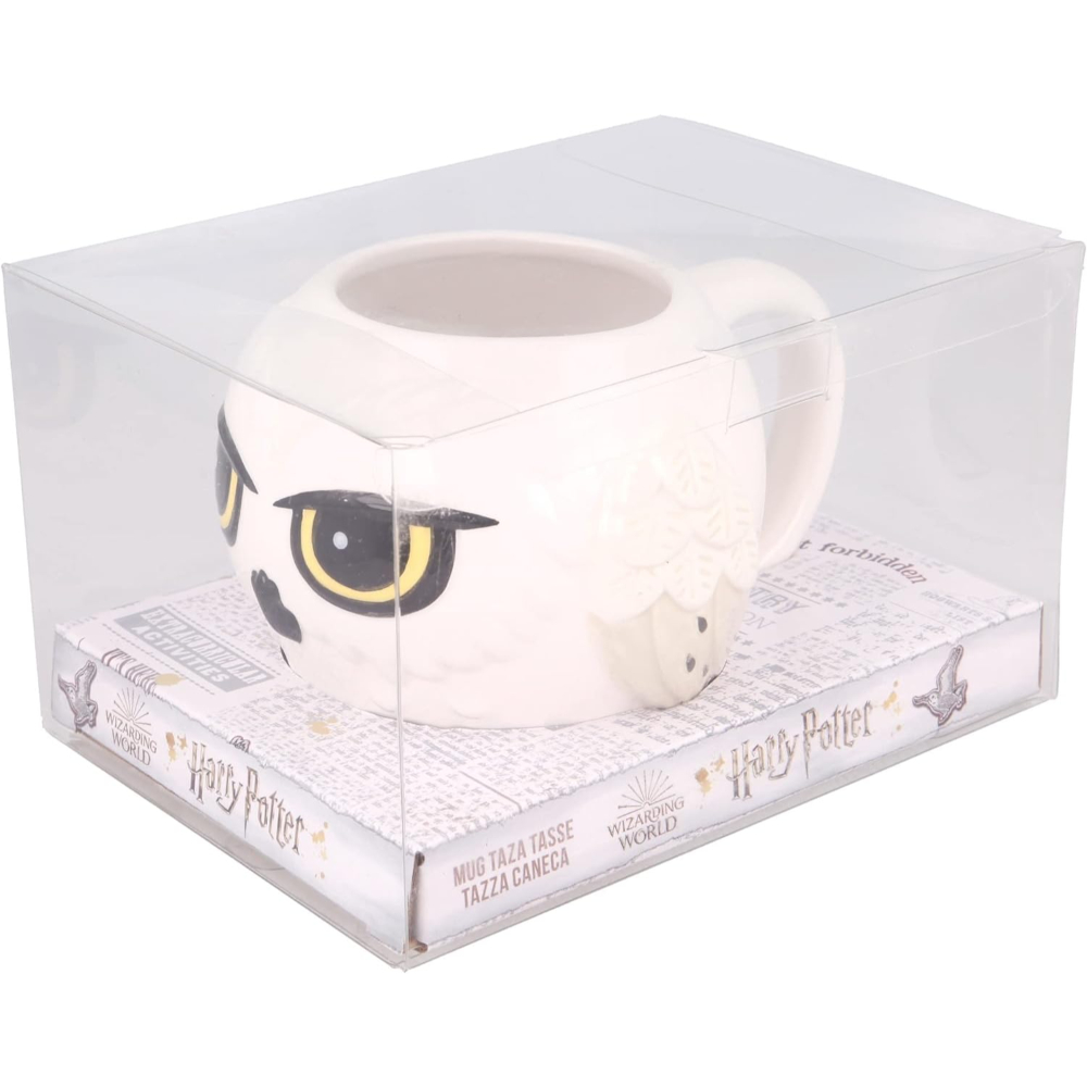 Taza de Harry Potter con un búho blanco. La taza está en una caja transparente con 'Harry Potter'.