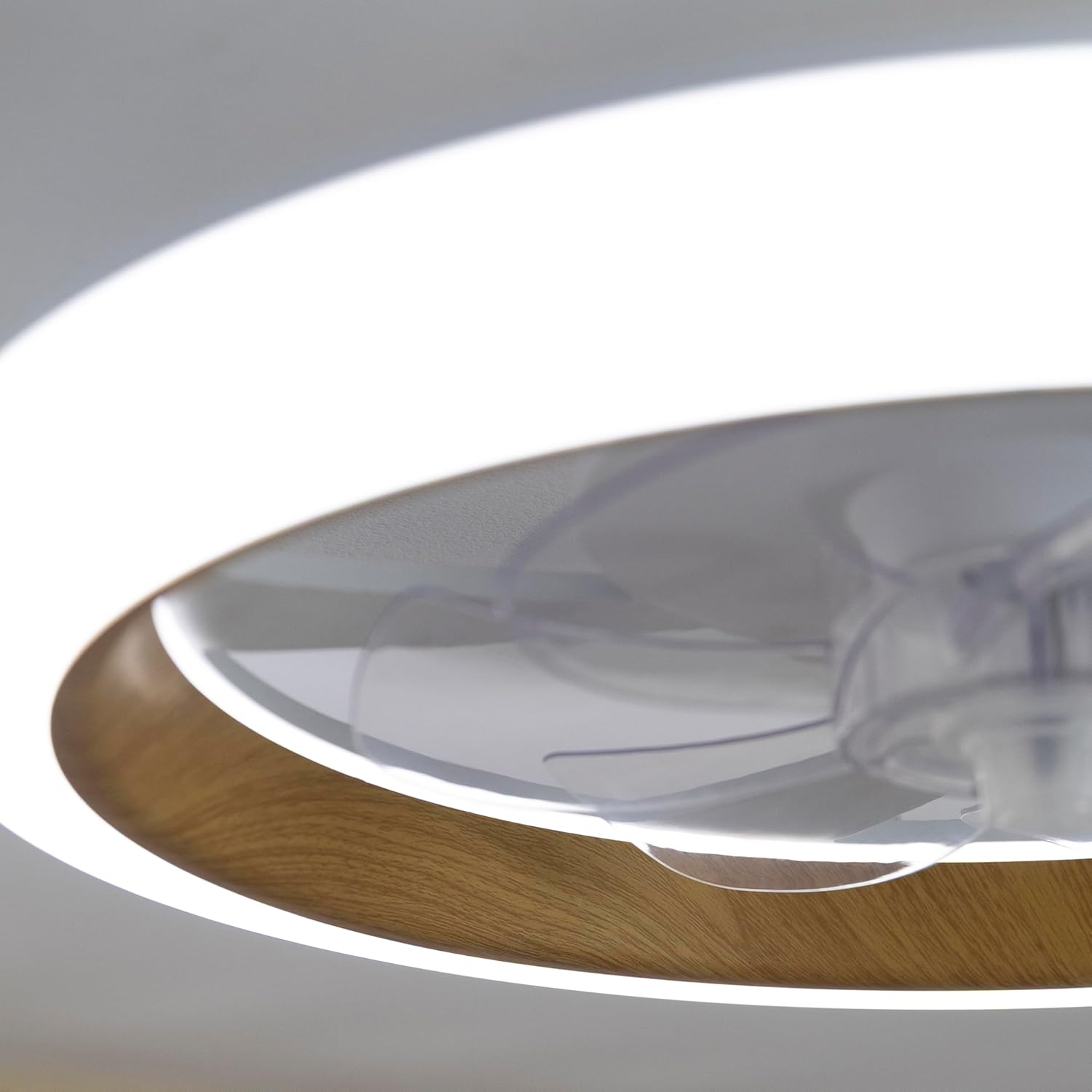 Ventilador de techo con borde de madera y anillo de luz blanca.