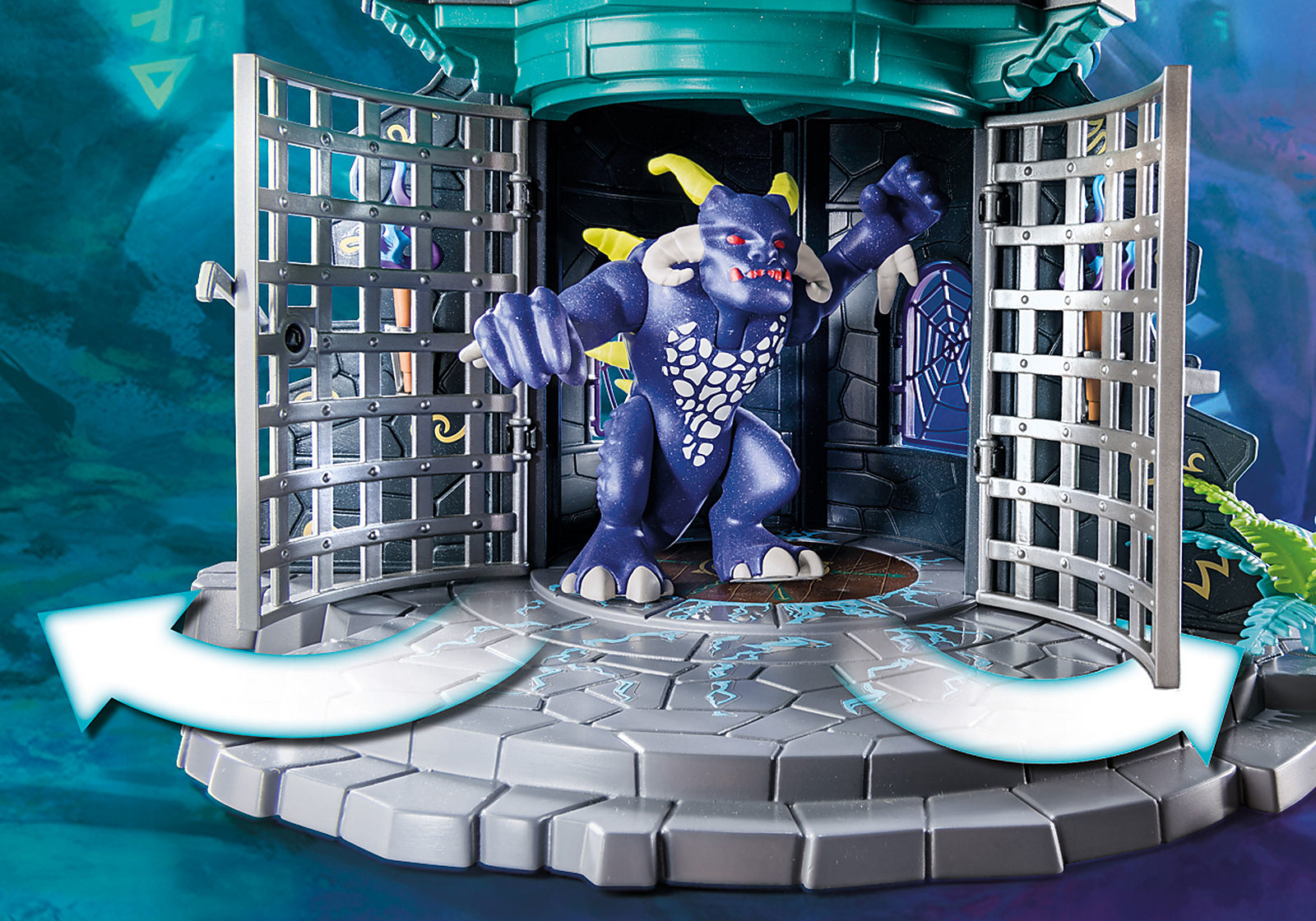 Scena del castello Playmobil con un mostro, cancelli aperti e un interno di prigione.