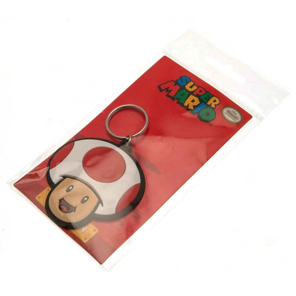 Un llavero de hongo de Super Mario en una bolsa de plástico con una tarjeta roja.