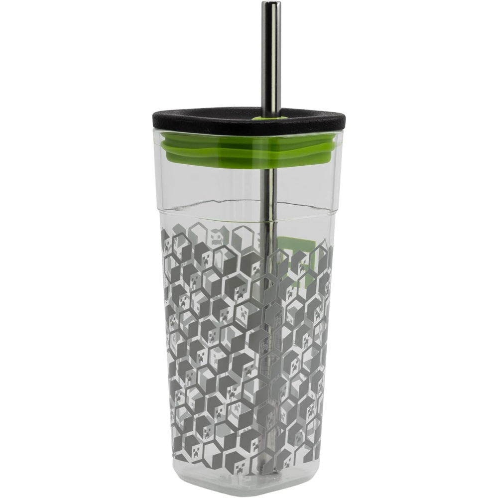 Vaso de vidrio transparente con patrón hexagonal, tapa negra, borde verde y pajita metálica.