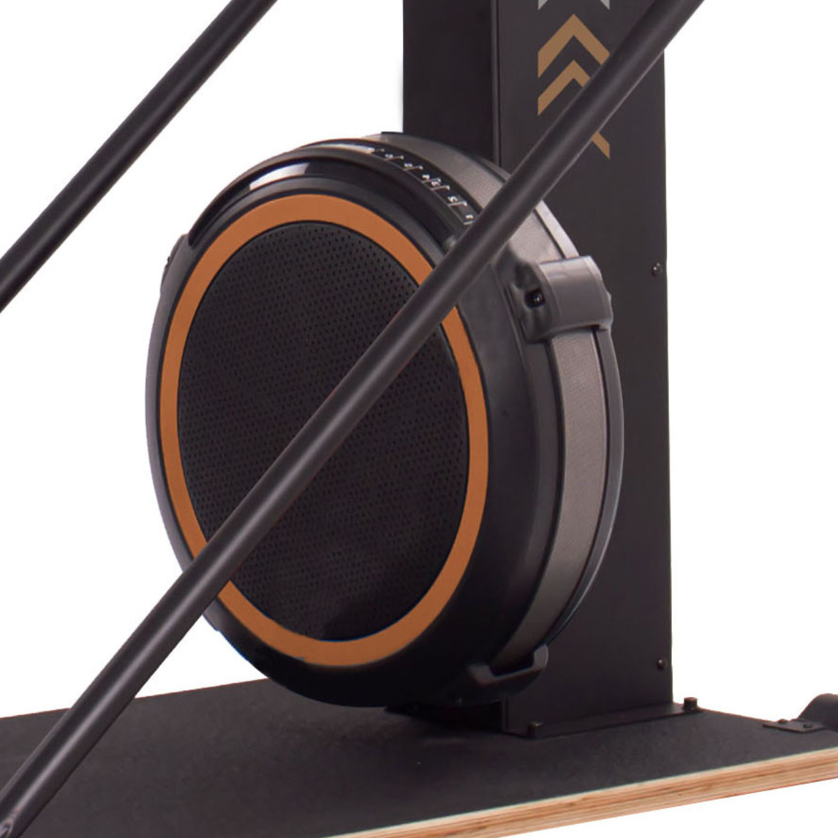 Close-up of the flywheel and rails of a black and orange exercise rowing machine.