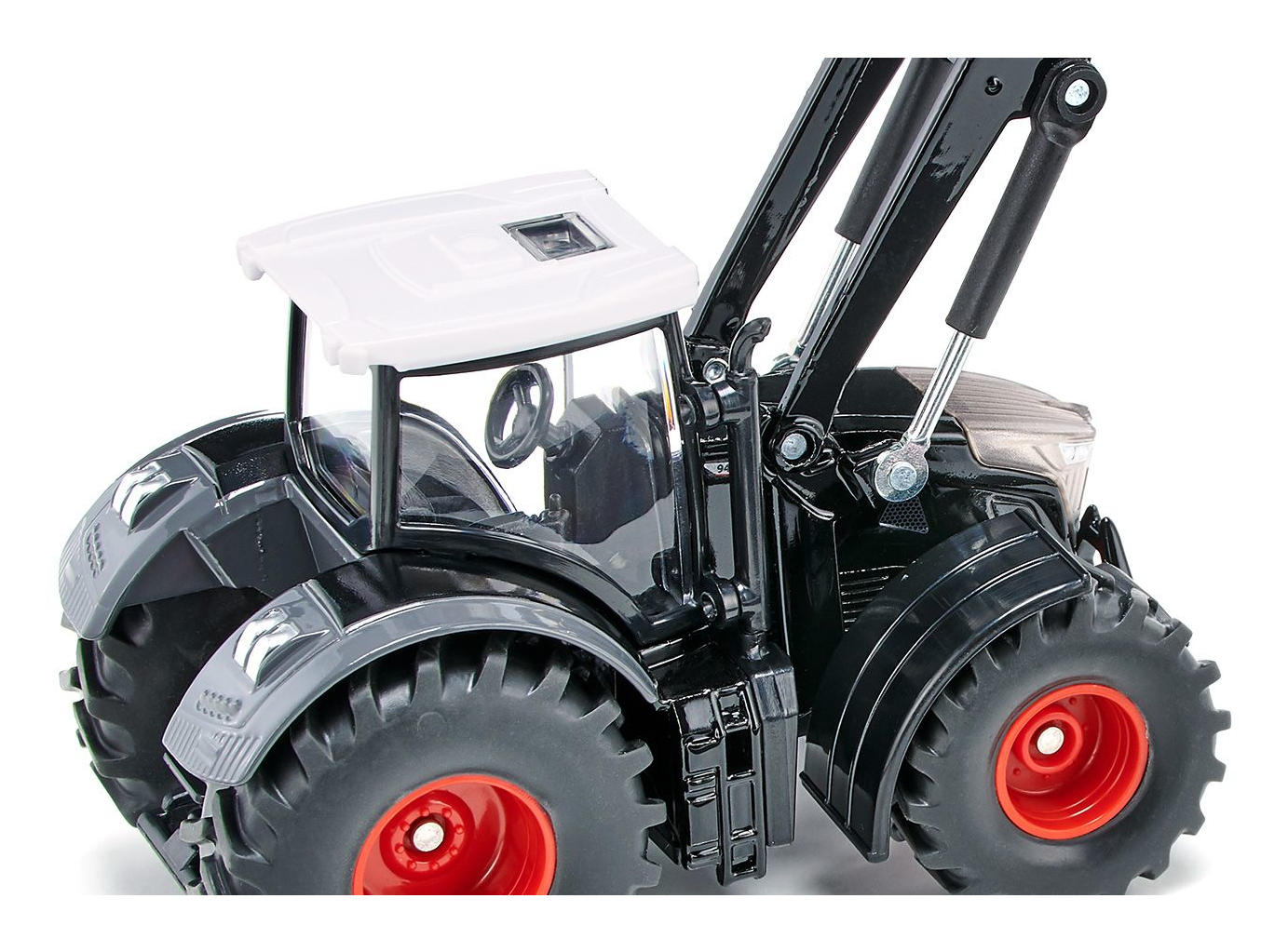 Czarny i szary traktor zabawka z ładowaczem czołowym i czerwonymi felgami. Białe tło.