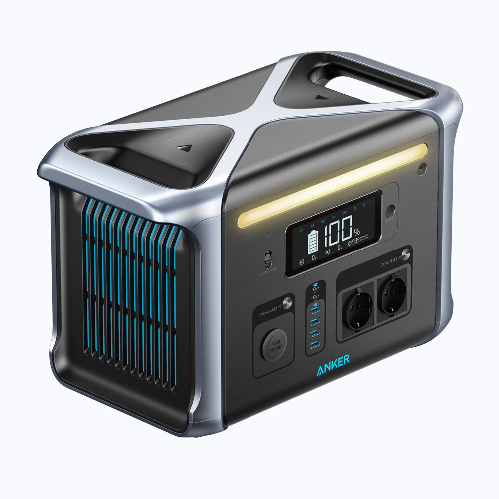 Czarno-srebrna elektrownia z wyświetlaczem, portami i uchwytem. Pokazuje 100% naładowania.