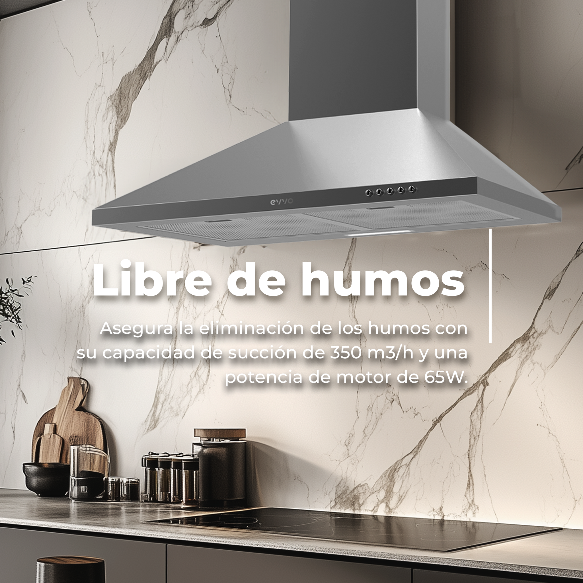 Una campana extractora de acero inoxidable sobre una placa de cocción negra. Fondo de mármol blanco.