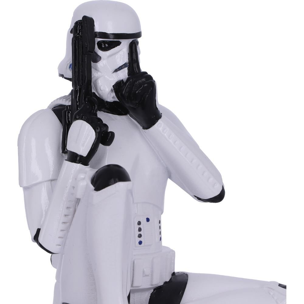 Stormtrooper beeldje, zittend en een pistool vasthoudend, terwijl het een 'shush' gebaar maakt.