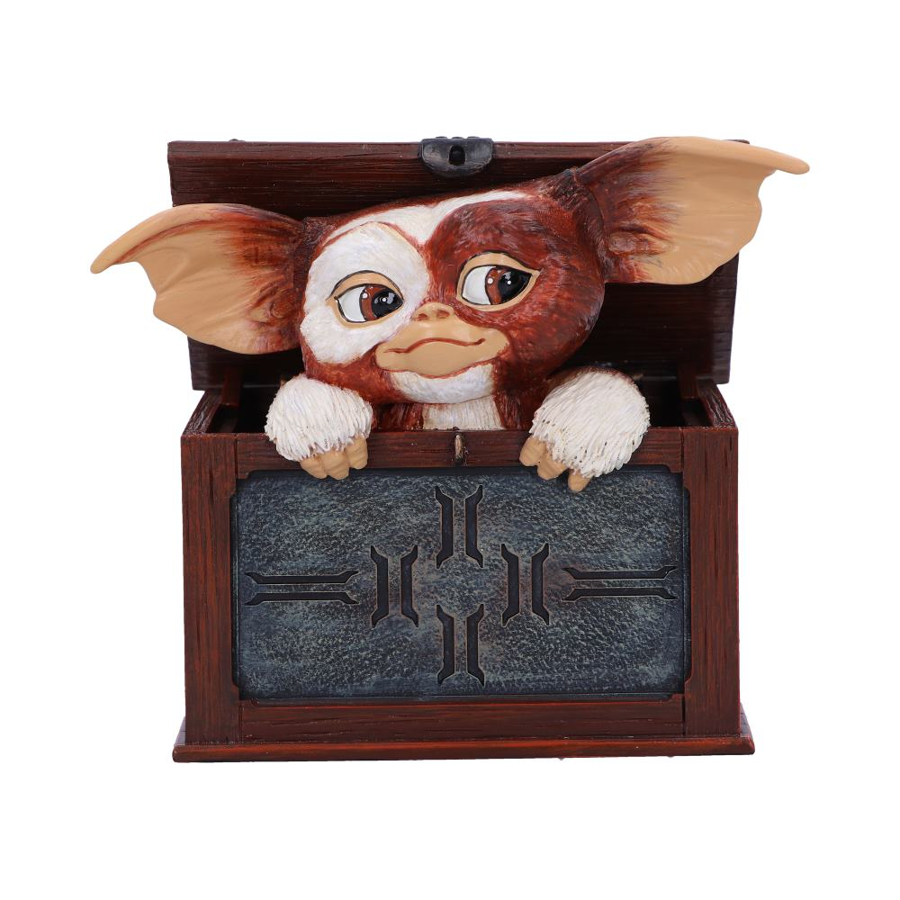 Een Gremlin-pop die uit een houten kist komt, met een gedetailleerd gezicht.