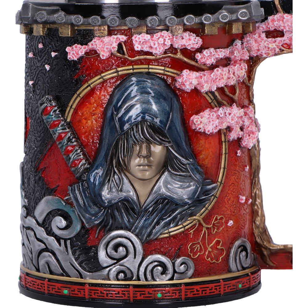 Mug with a cloaked figure, cherry blossoms, and a red background with a Japanese theme.