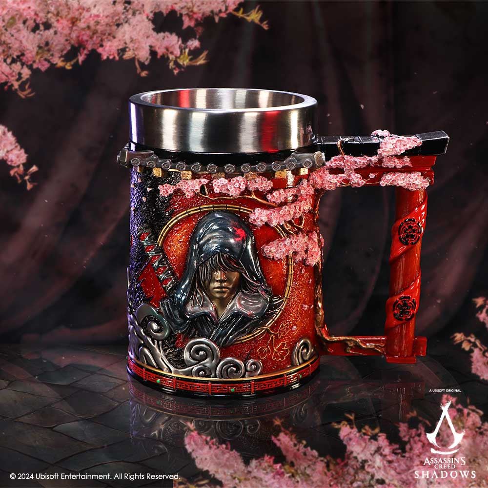 Assassin's Creed mug with red and black design. Features a character portrait, cherry blossom accents, and ornate handle.