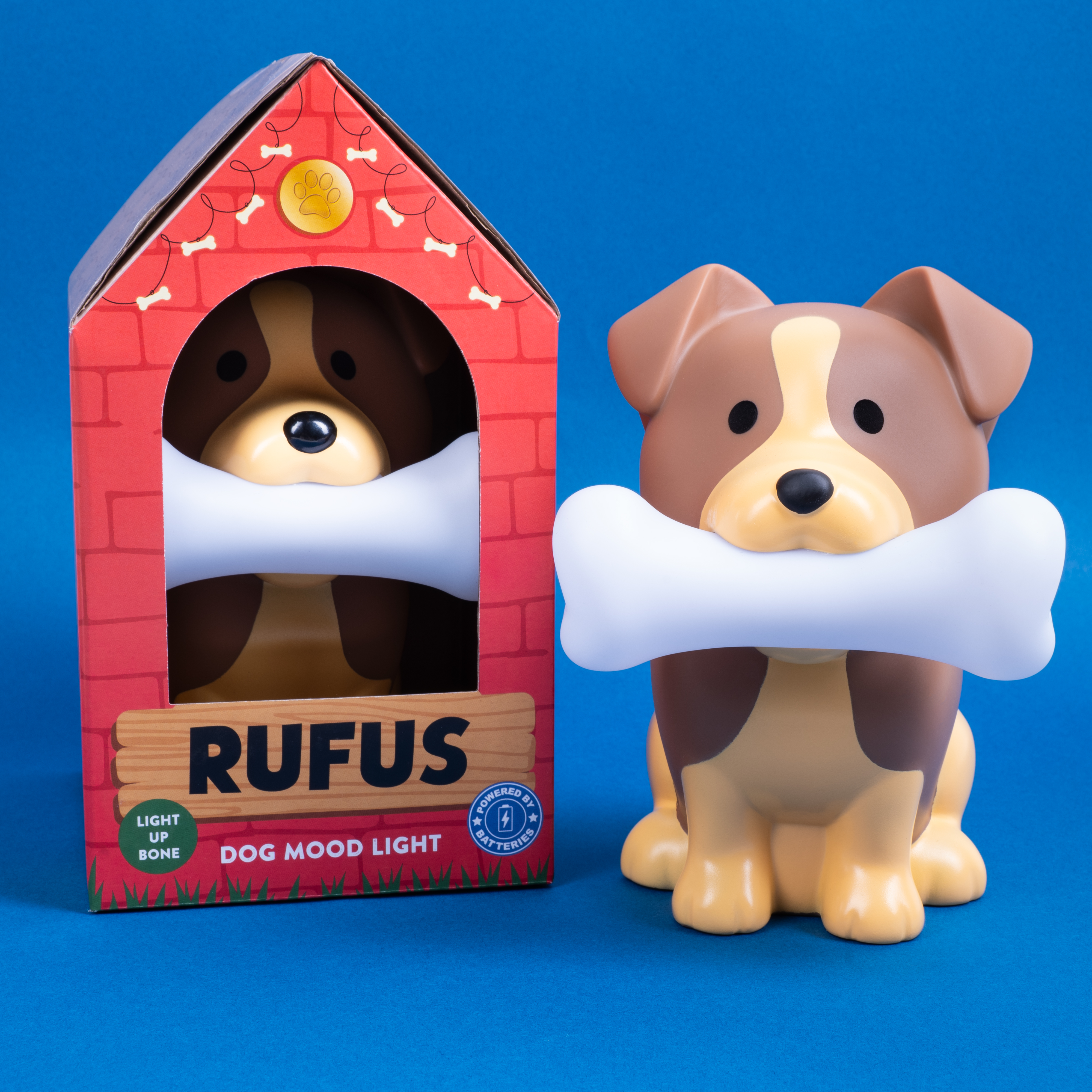 Dog-shaped night light in box, with a bone. Blue background.