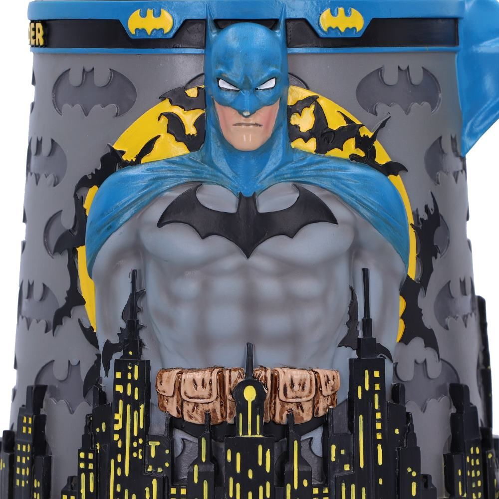 A Batman mug with a Batman figure on it. The background is a cityscape with Batman symbols.