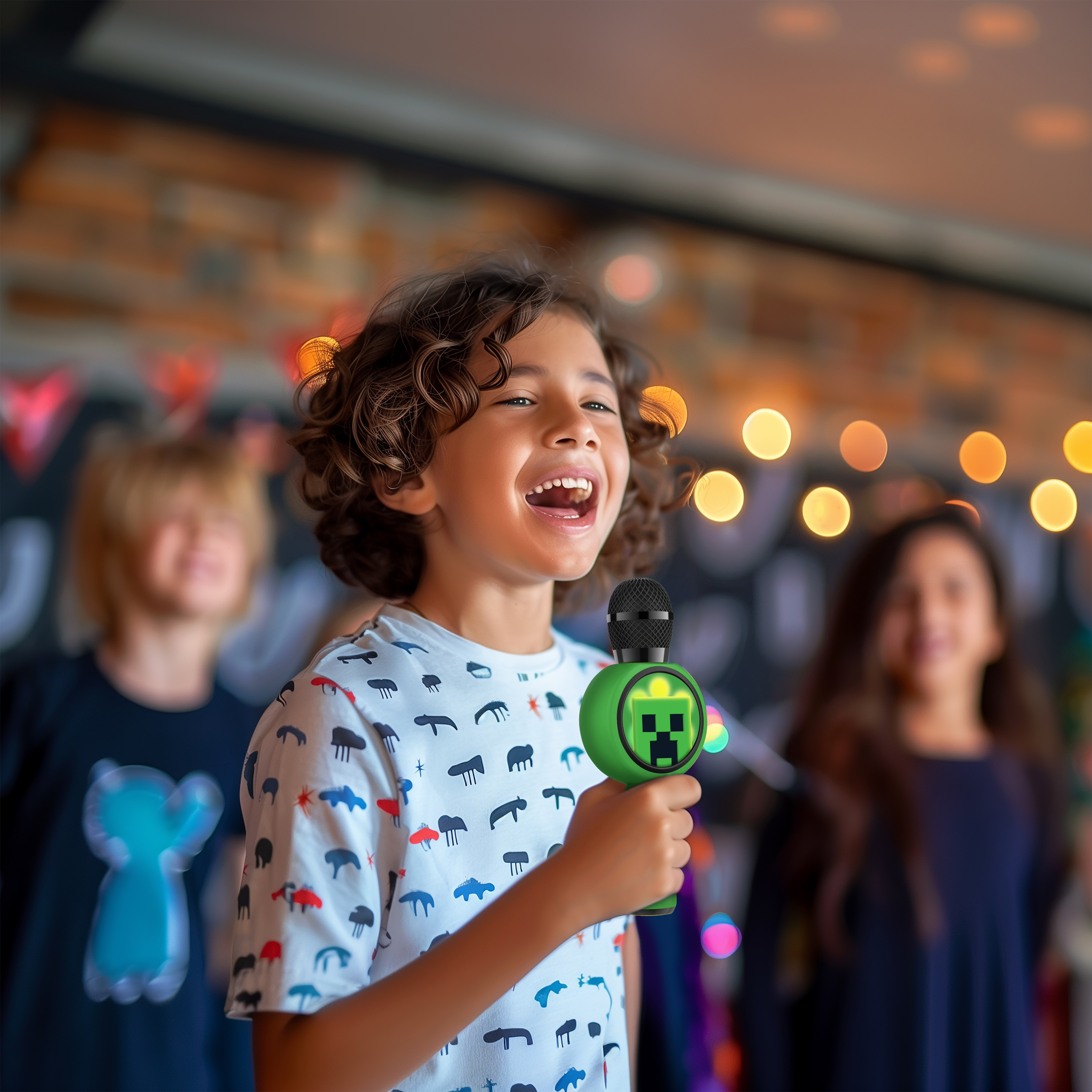 A child singing into a green microphone. Two other children are in the background.
