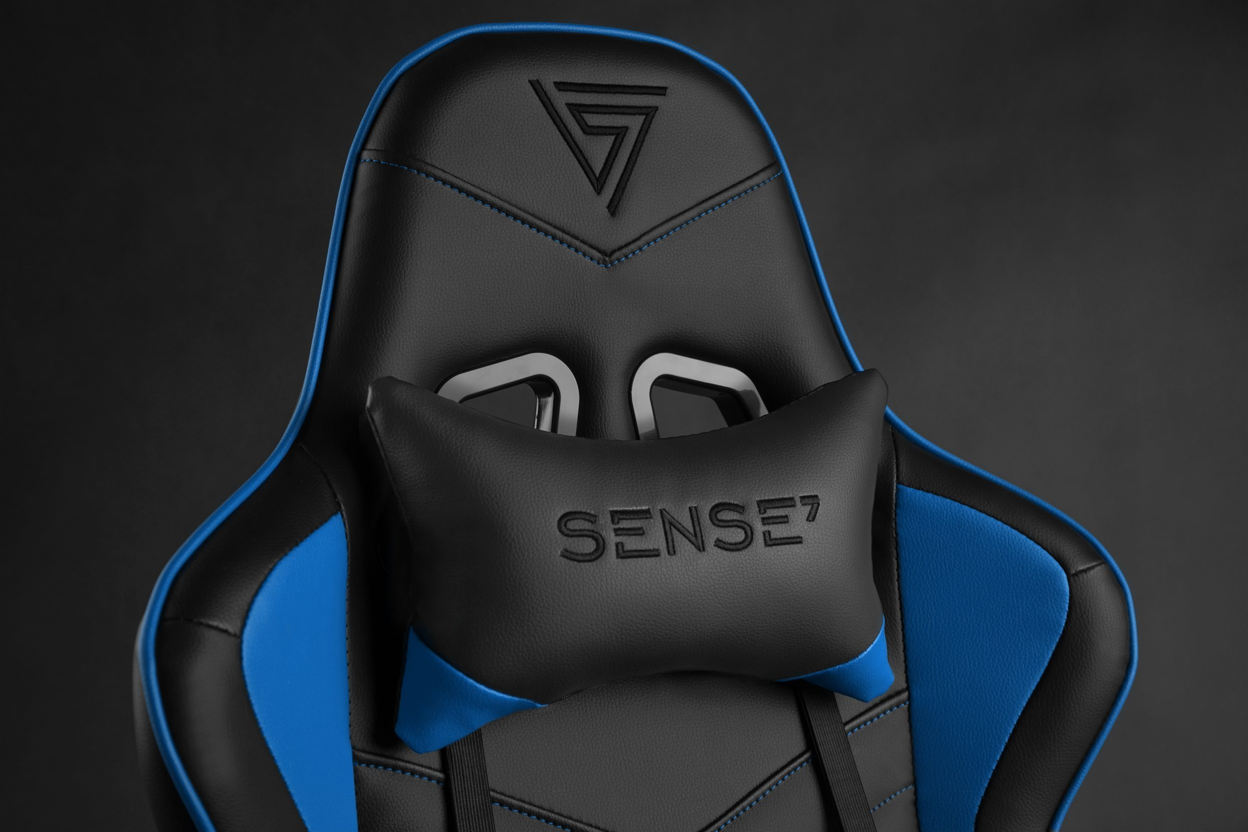 Gaming-Stuhl mit schwarzen und blauen Akzenten, mit einer Kopfstütze mit der Aufschrift „SENSE7“.