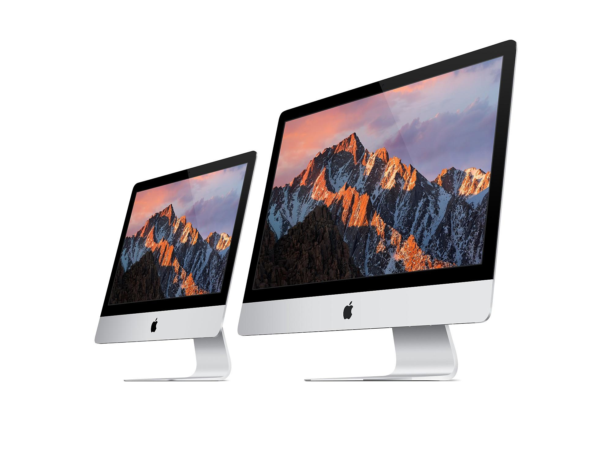Dwa komputery iMac obok siebie, pokazujące scenę górską na ekranach.