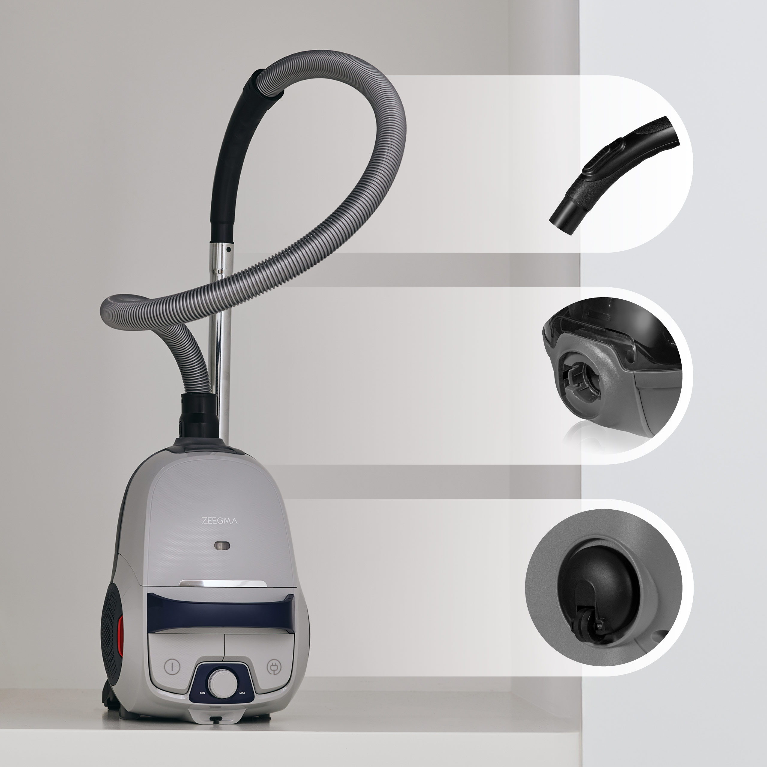 Odkurzacz. Ma rurę i nasadki. Odkurzacz jest szary i czarny.