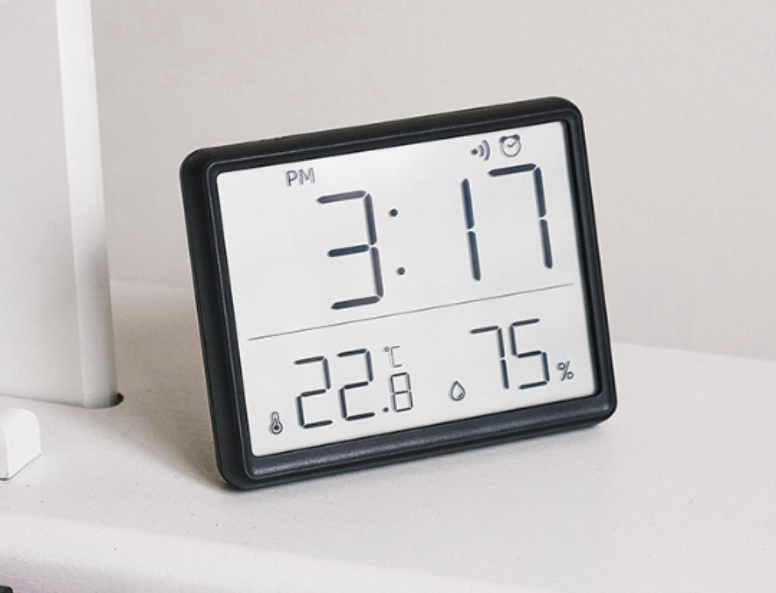 Digitaluhr zeigt Zeit (15:17), Temperatur (22,8°C) und Luftfeuchtigkeit (75%).