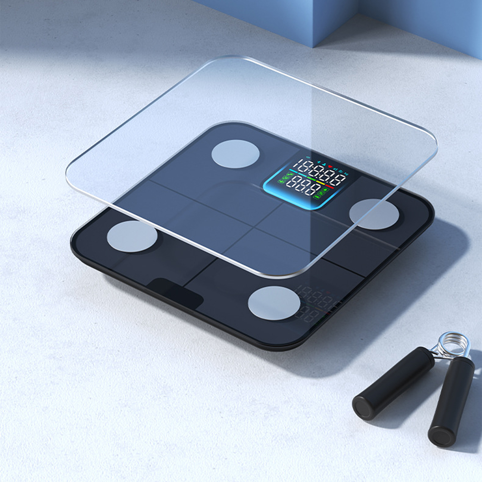 Schwarze Digitalwaage mit transparentem Deckel und zwei Handtrainer.