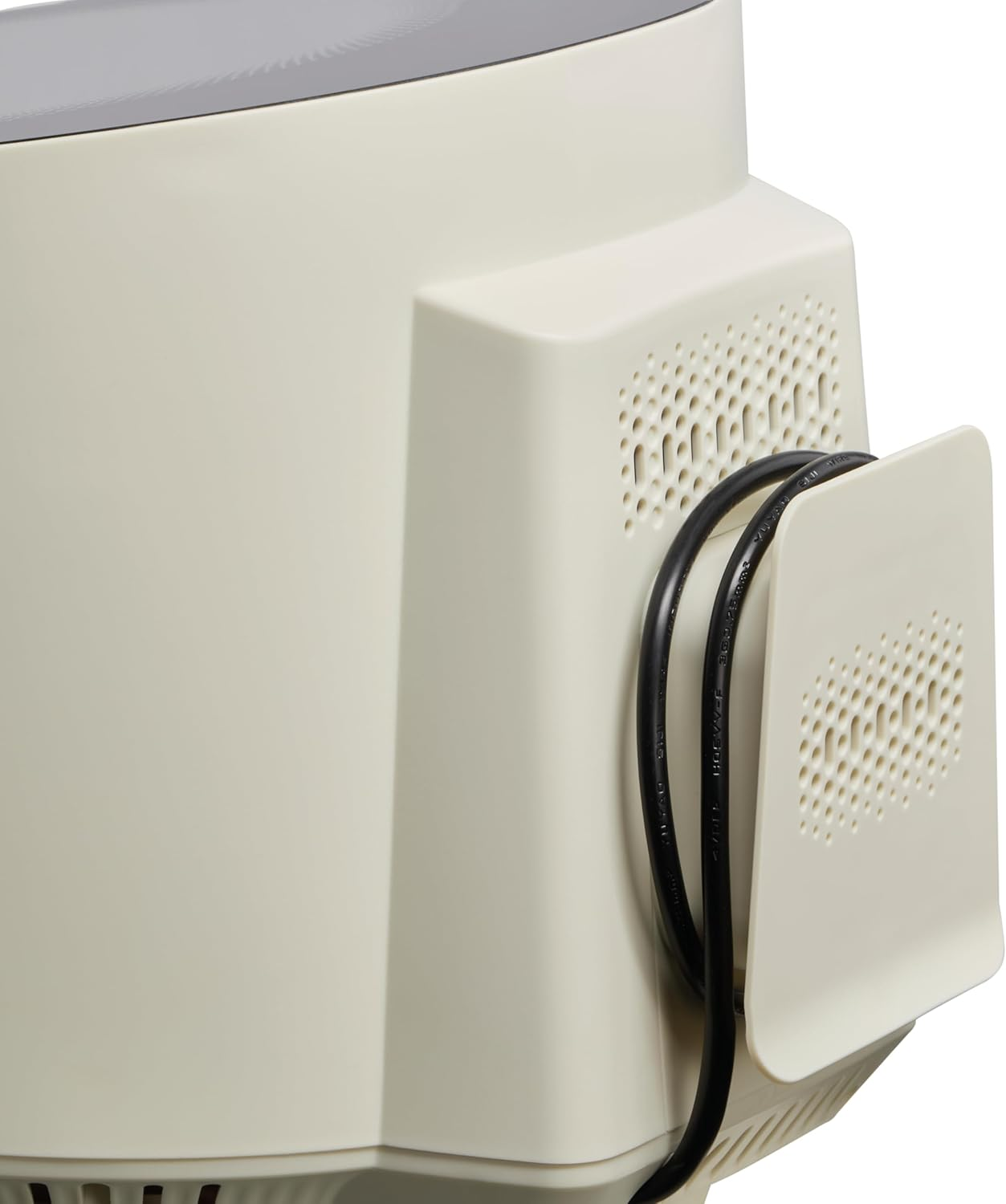 Un primo piano del retro di un monitor beige con un supporto per cavi.