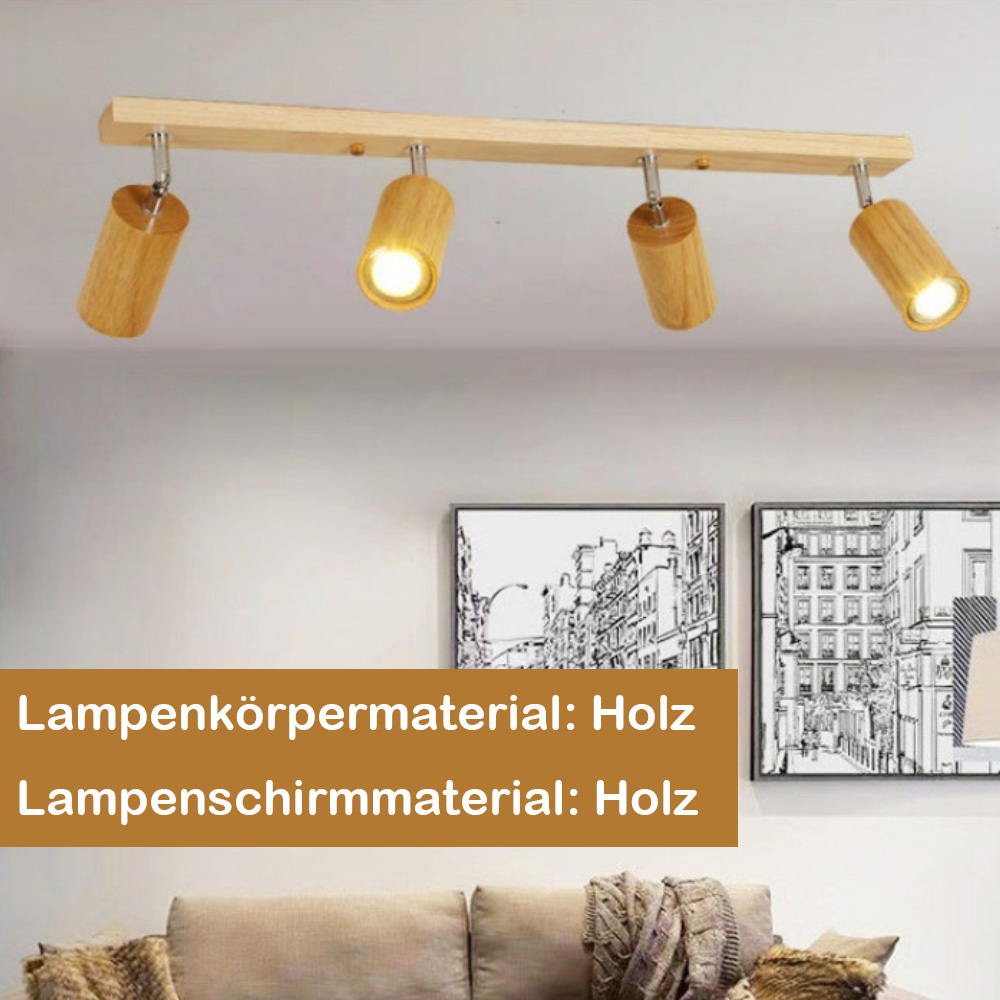 Holz Deckenleuchte mit vier Strahlern. Zwei Gemälde im Hintergrund und ein Sofa darunter.