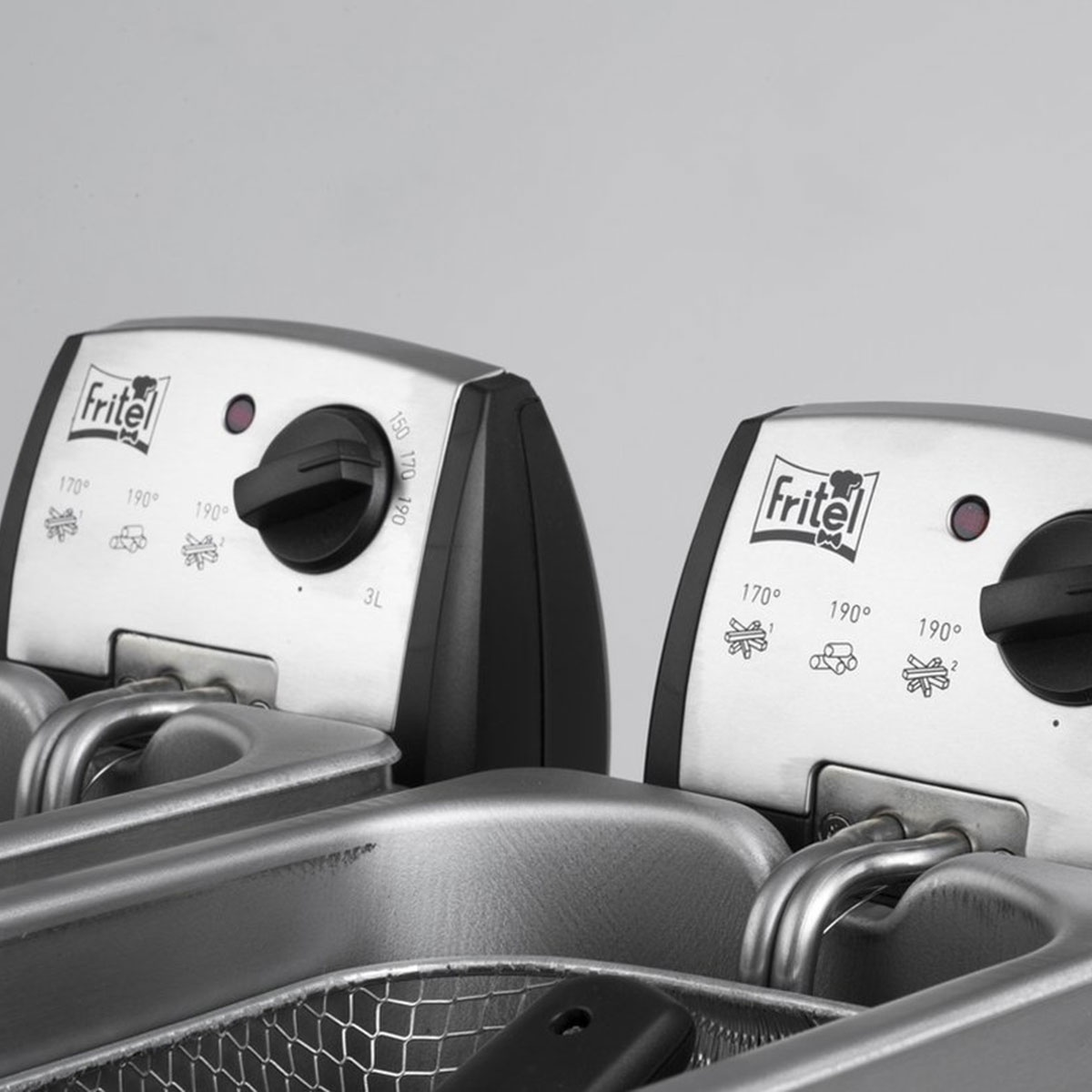 Close-up of two stainless steel deep fryers, both with controls and baskets inside.