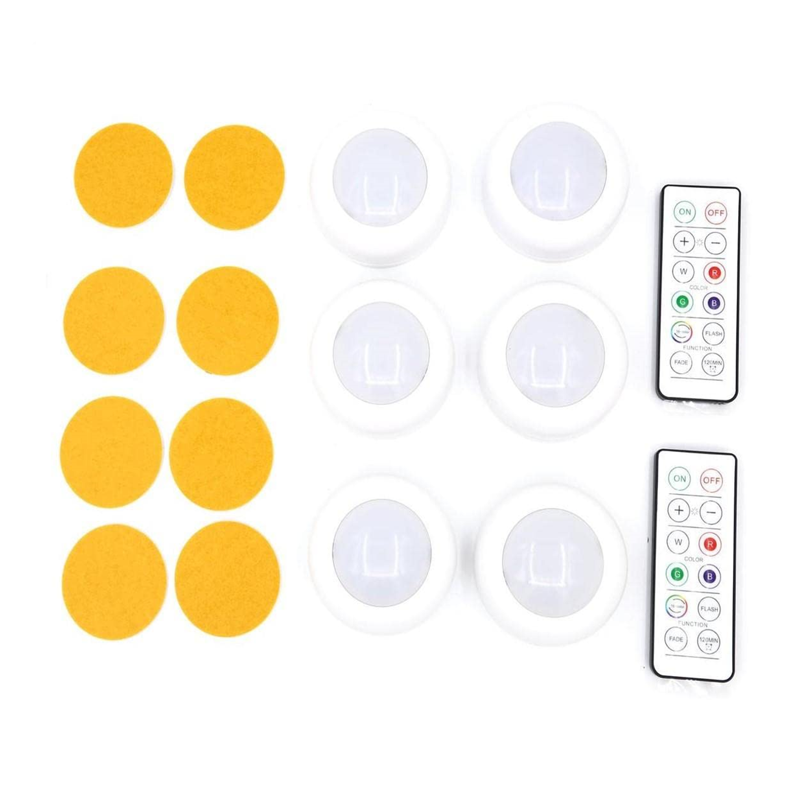 Sechs weiße Puck-Lichter und zwei Fernbedienungen. Außerdem sind sechs gelbe Klebepads zu sehen.