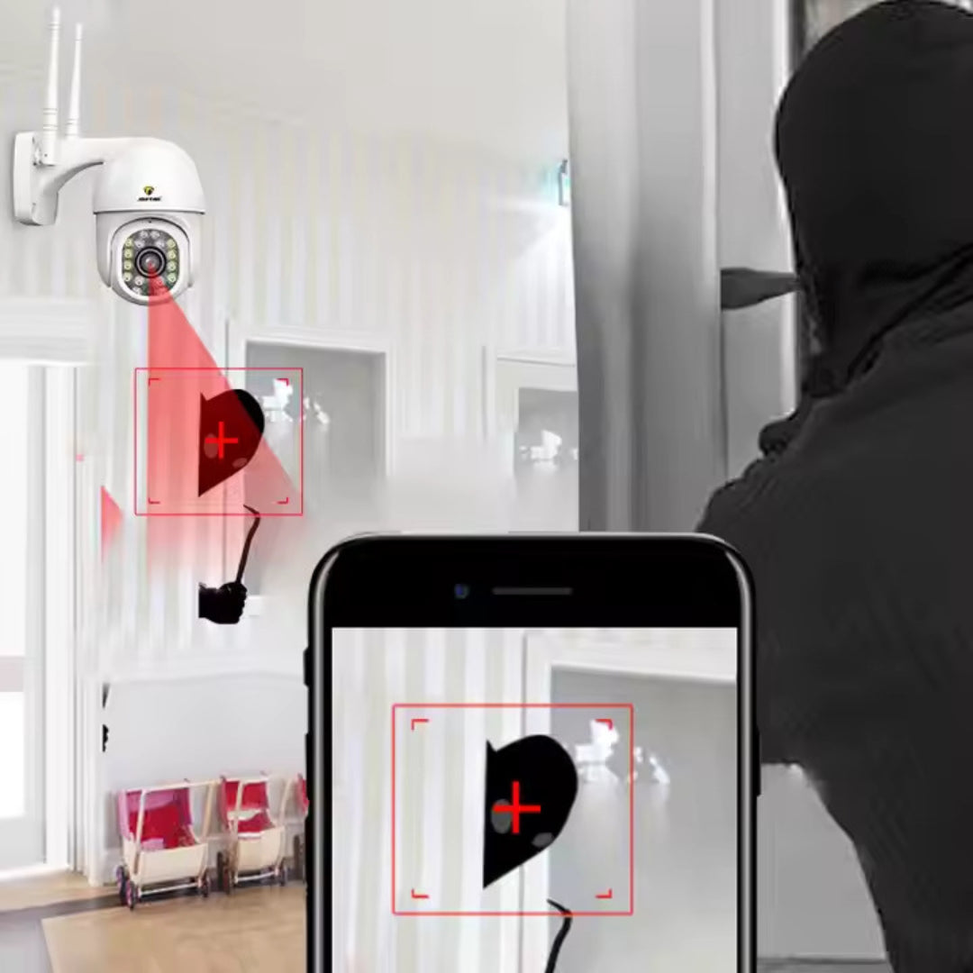Una cámara de seguridad en una pared con una zona de detección roja. Una persona está en el área de detección en la pantalla de un teléfono.