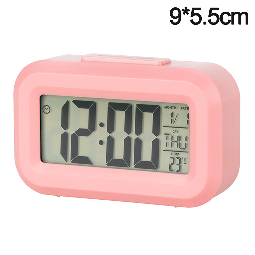 Ein rosafarbener digitaler Wecker, der 12:00 anzeigt, mit Datum und Temperatur.