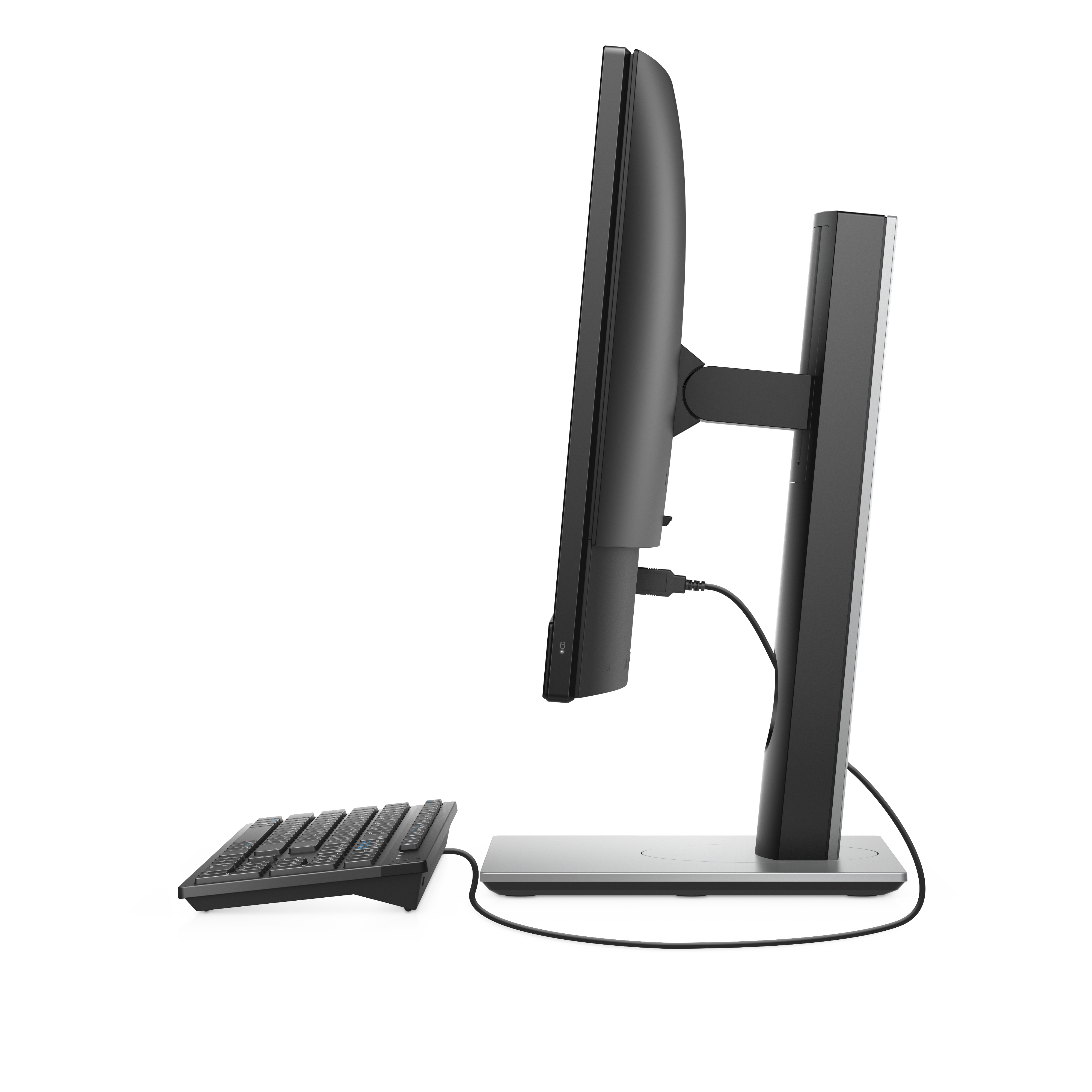Side view of a black computer. Keyboard and stand are also visible. White background.