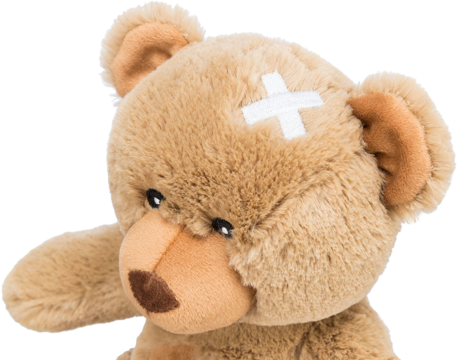 Brązowy pluszowy miś z białym bandażem na głowie, patrzący w prawo.