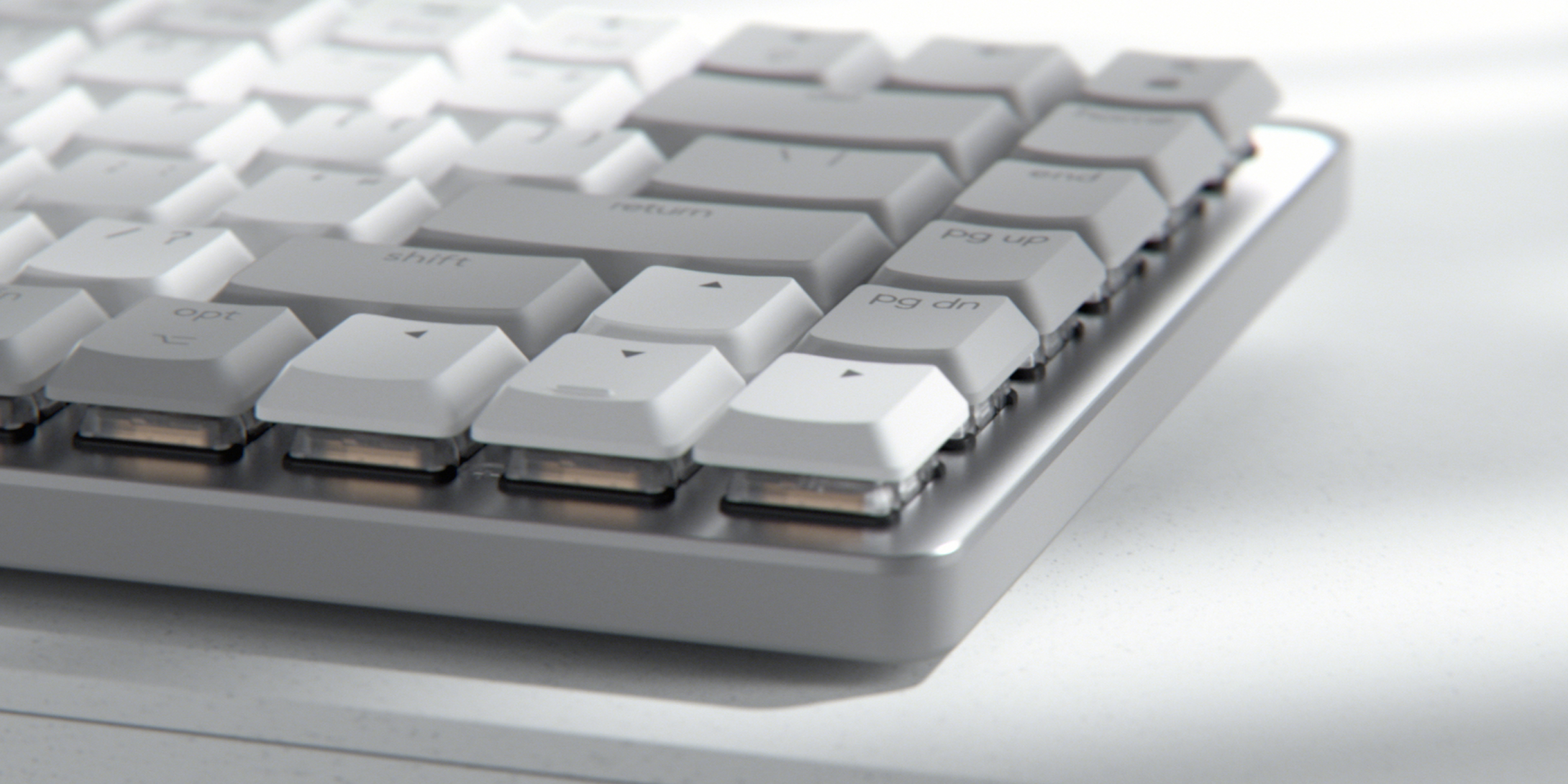Primer plano de un teclado blanco con teclas grises. El teclado está sobre una superficie blanca. Las teclas son visibles.