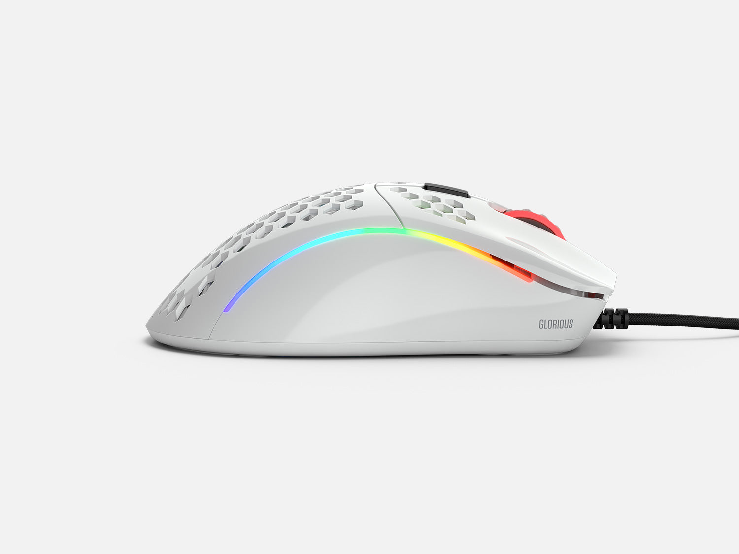 White gaming mouse with honeycomb design, angled view on white background.