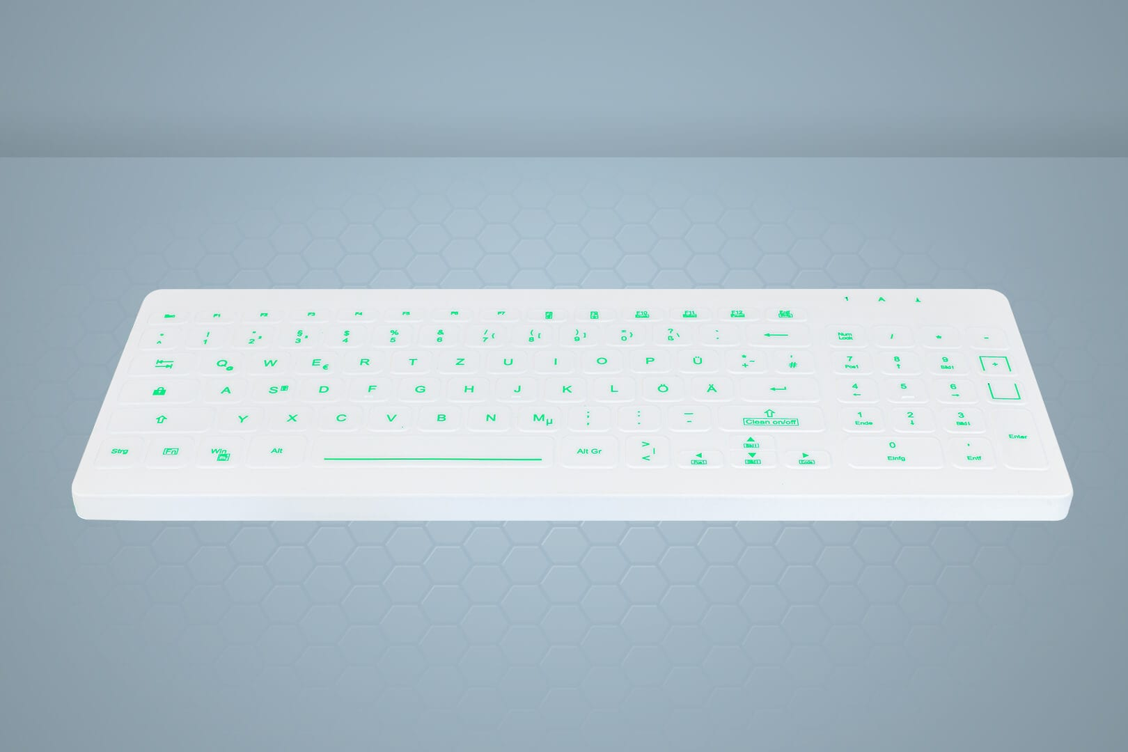 Eine weiße Tastatur mit grünen Buchstaben auf blauem Hintergrund mit sechseckigem Muster.