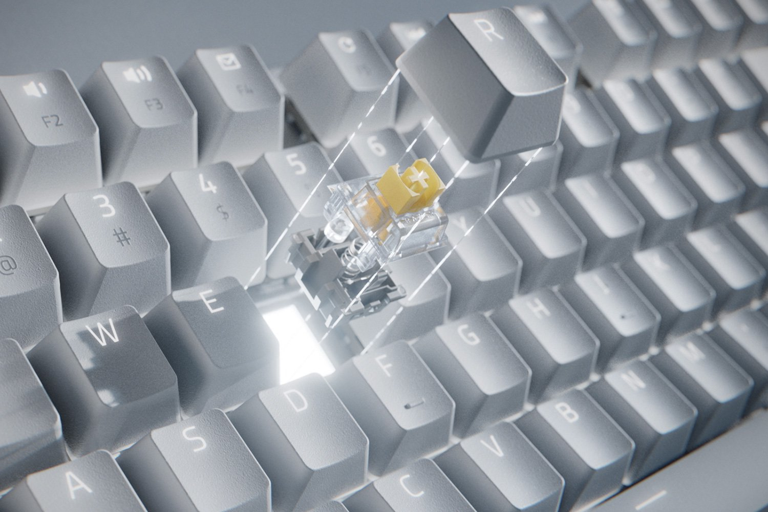 Un gros plan d'un clavier, montrant une touche retirée révélant l'interrupteur jaune.