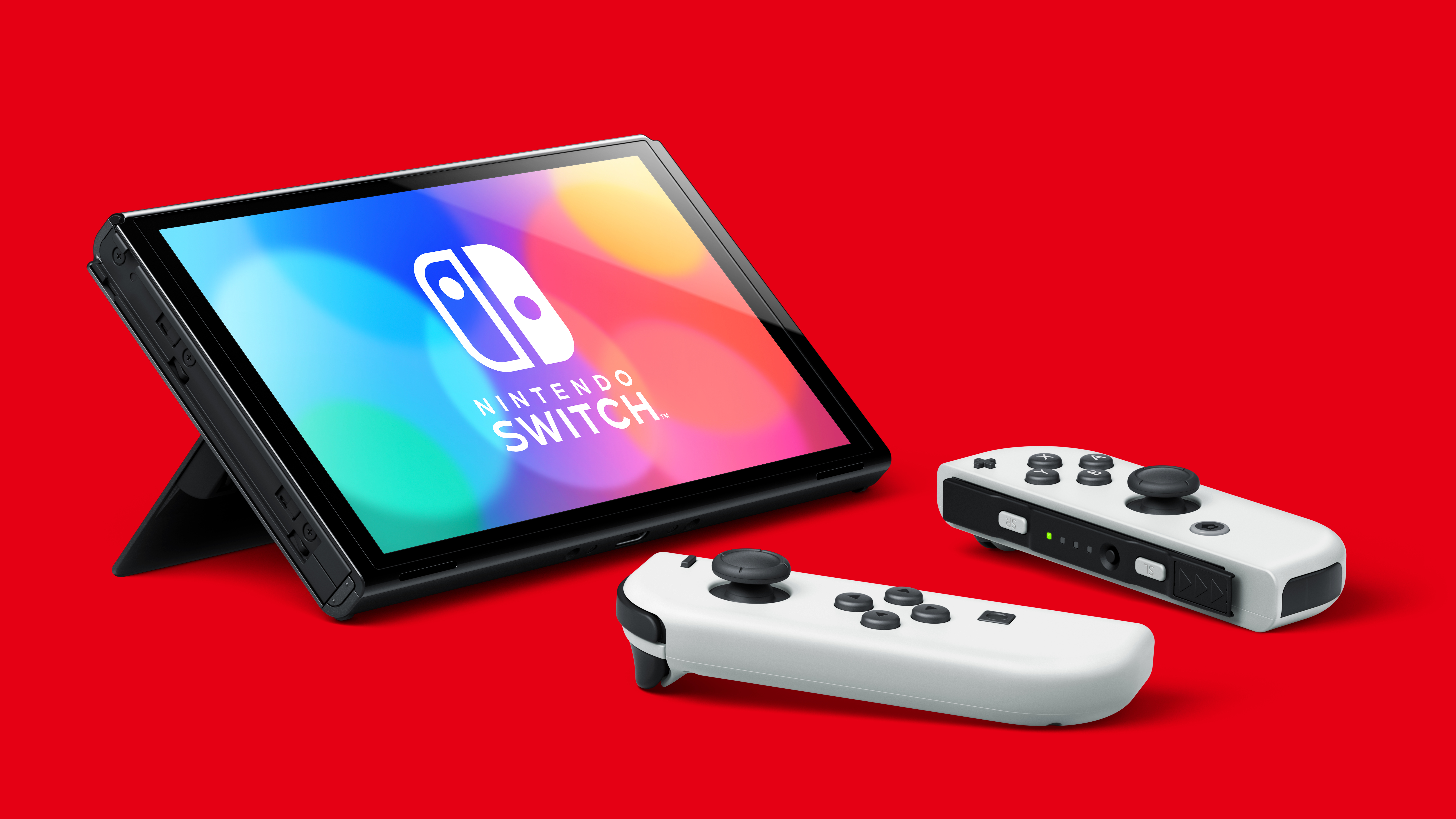 Konsola Nintendo Switch z Joy-Cons i podstawką na czerwonym tle, z logo Nintendo Switch.