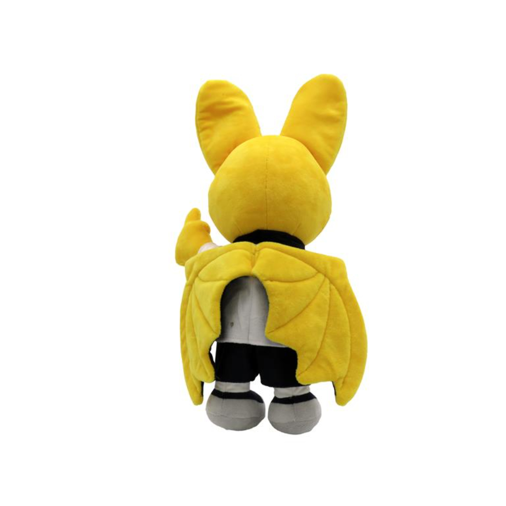 Un peluche de murciélago amarillo con camisa blanca, pantalón negro y alas amarillas, desde atrás.