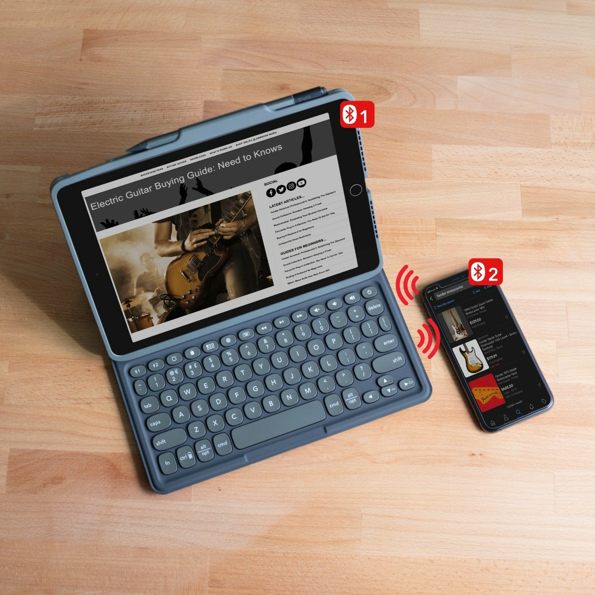 Tablet with keyboard and phone. Tablet displays a guitar guide. Phone shows guitar.