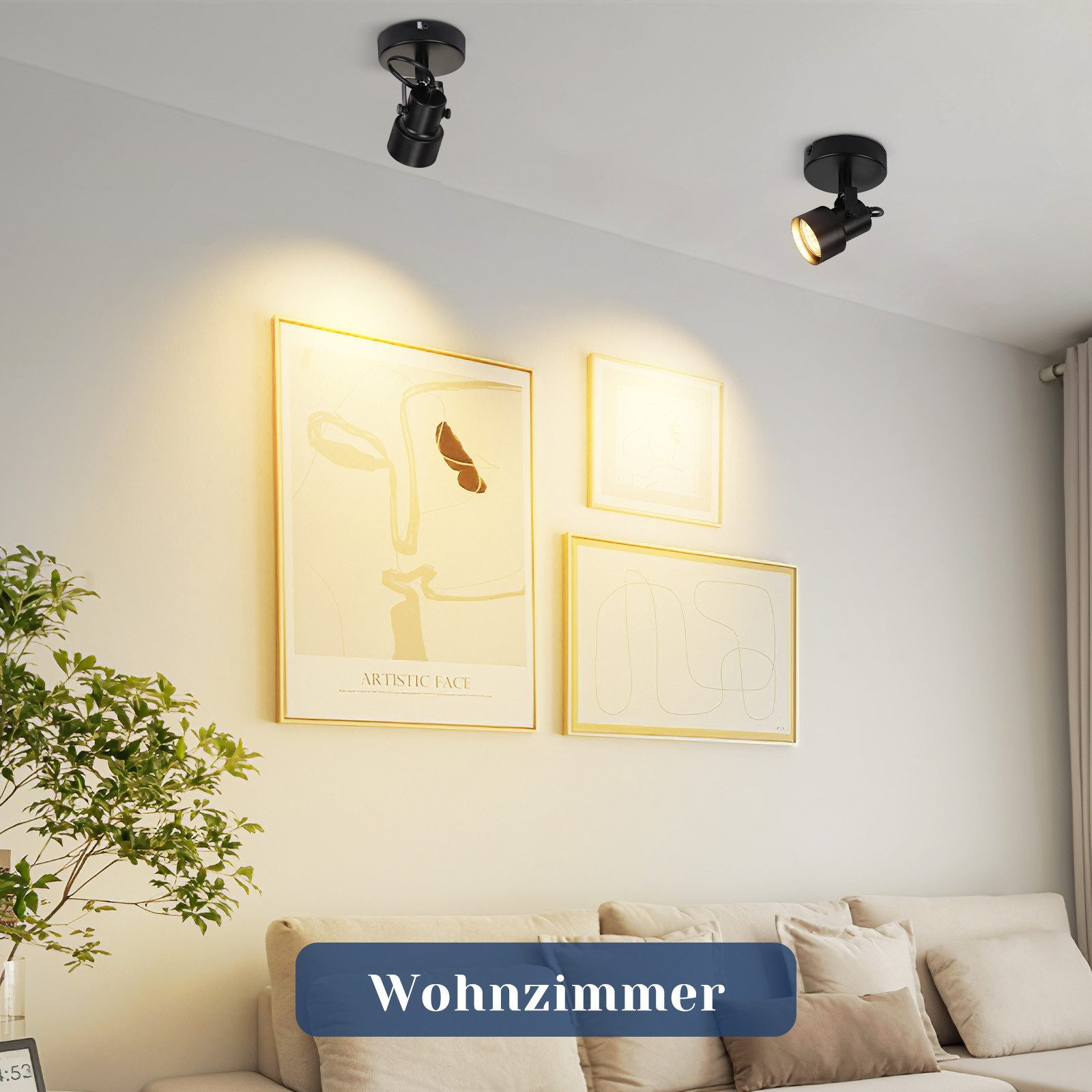 Dwa czarne reflektory na suficie, z dziełami sztuki i sofą w salonie.