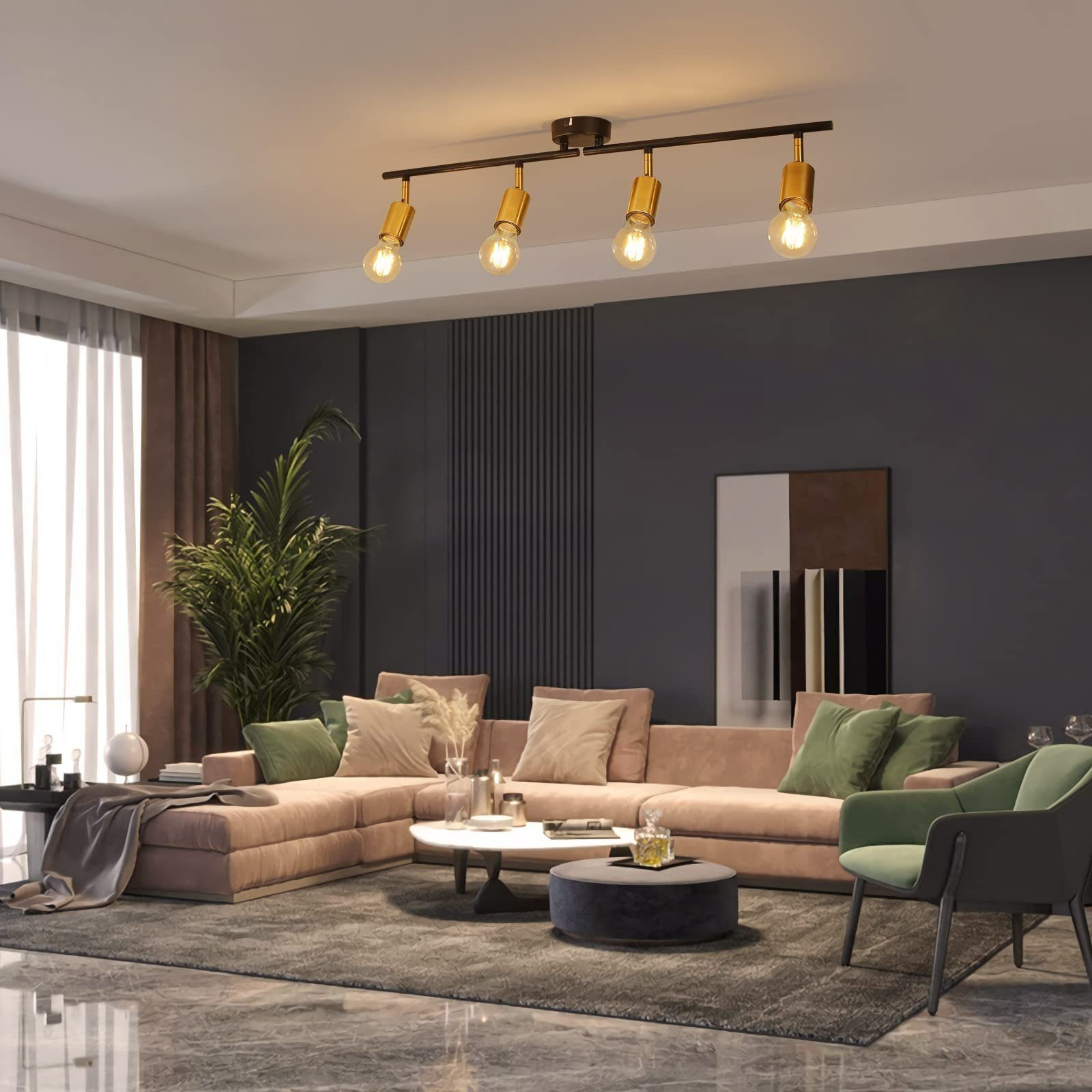 Salon z różową sofą, zielonym fotelem, stolikiem kawowym, dywanem i oprawą oświetleniową szynową.