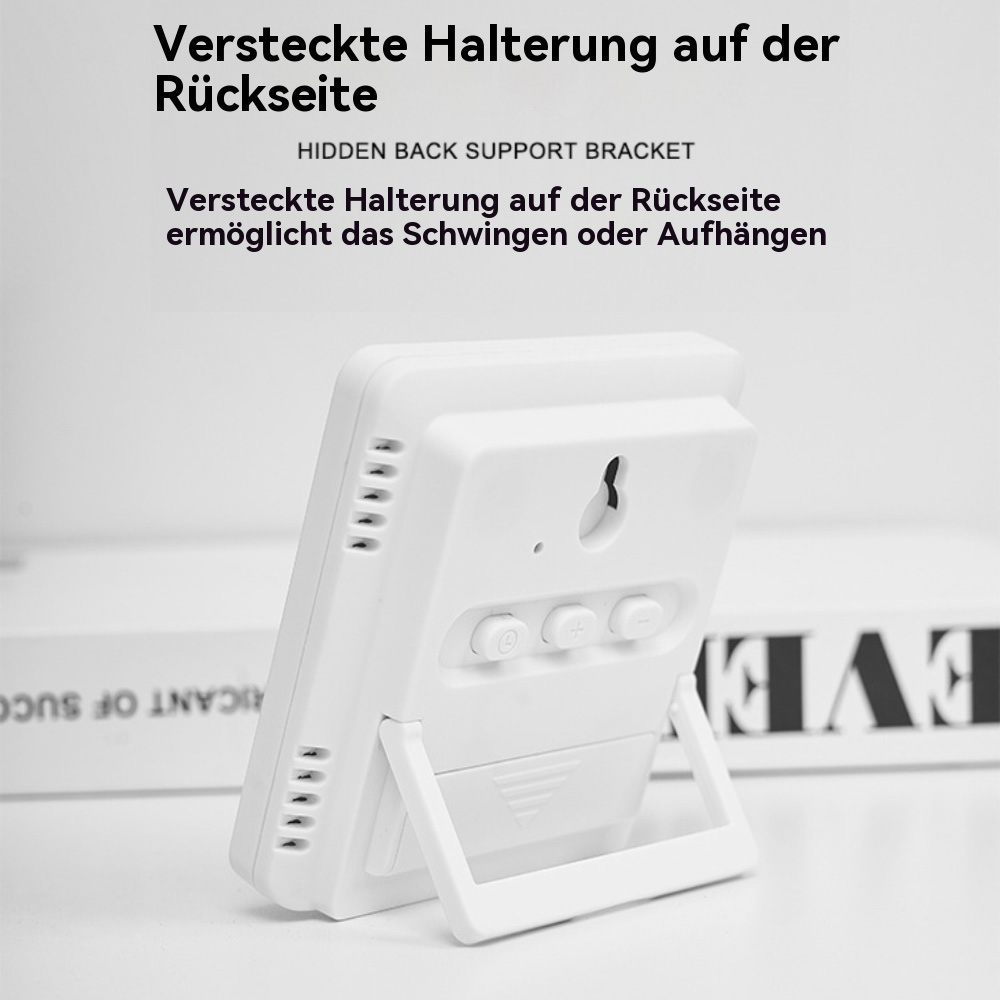 Weiße Digitaluhr mit Knöpfen und Ständer. Text zeigt versteckte Halterung an.