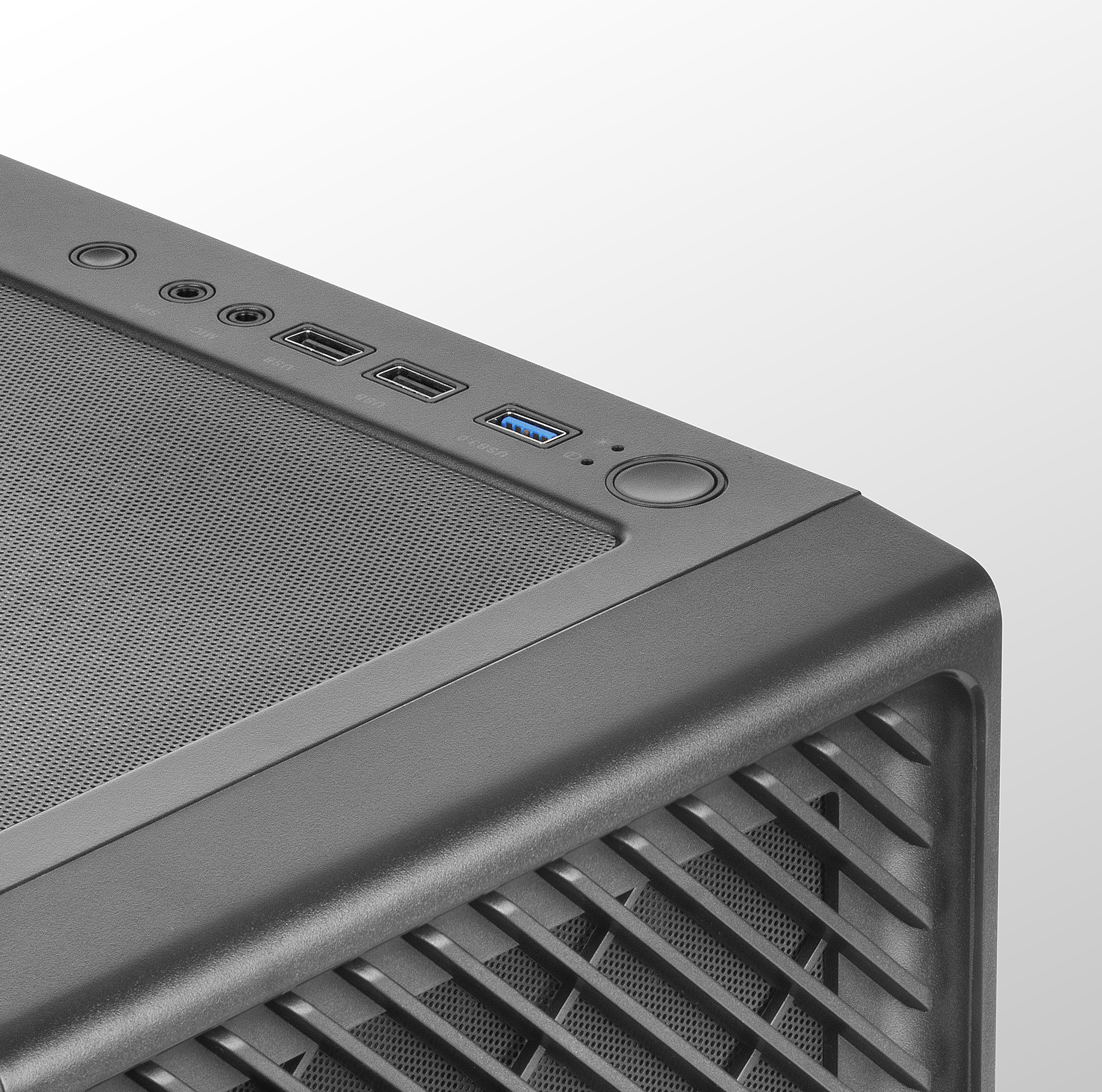 Górny róg obudowy komputera. Widoczny przycisk zasilania i porty, z obszarem wentylacyjnym.