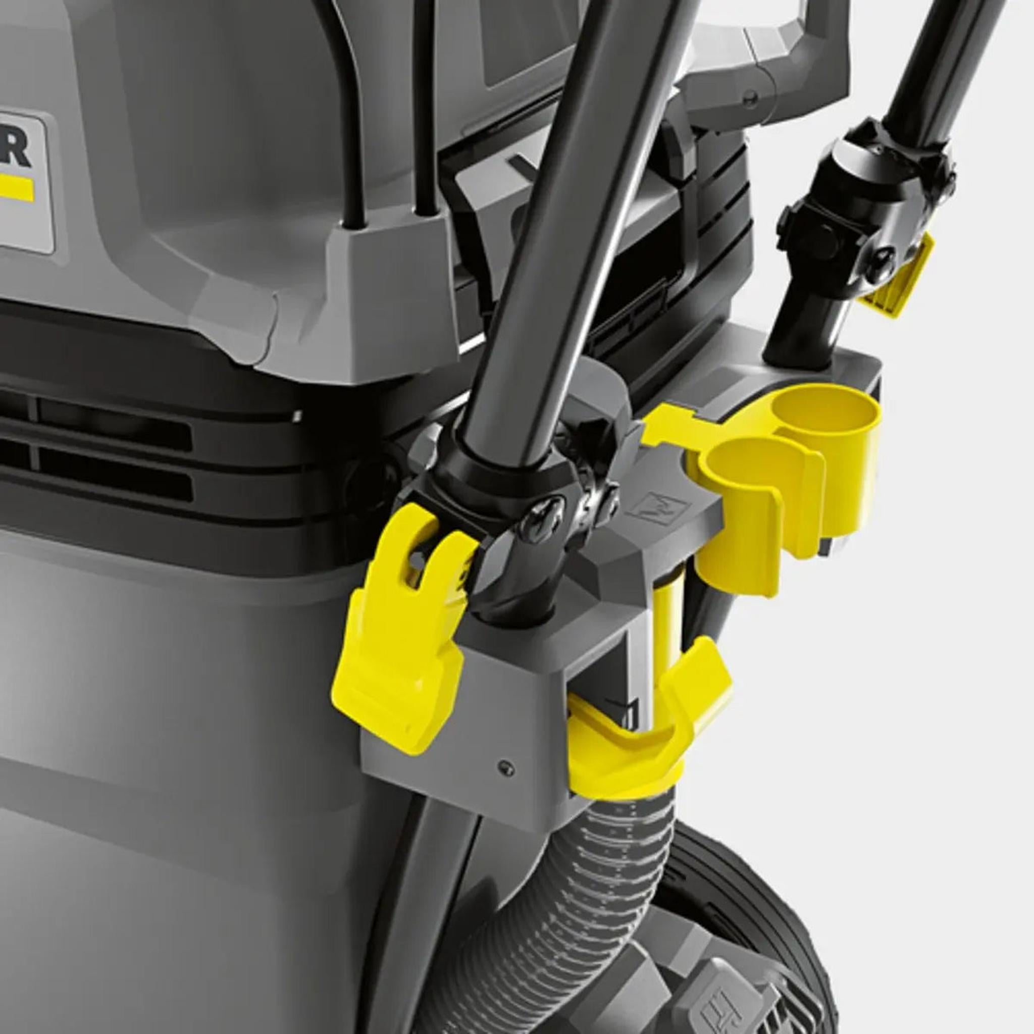 Vacuum cleaner, grey and yellow details. The hose is connected.