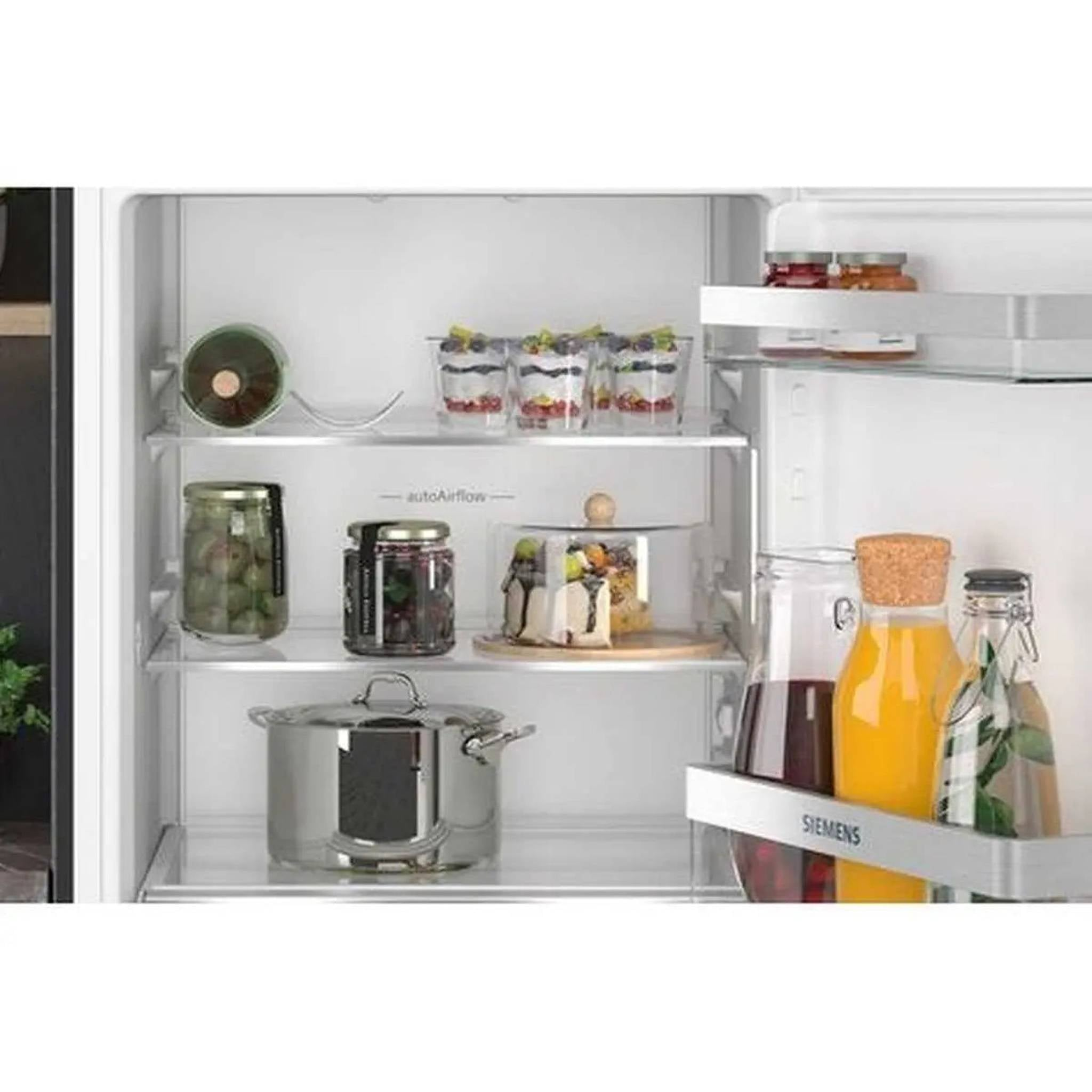 Open refrigerator with shelves filled with food items.