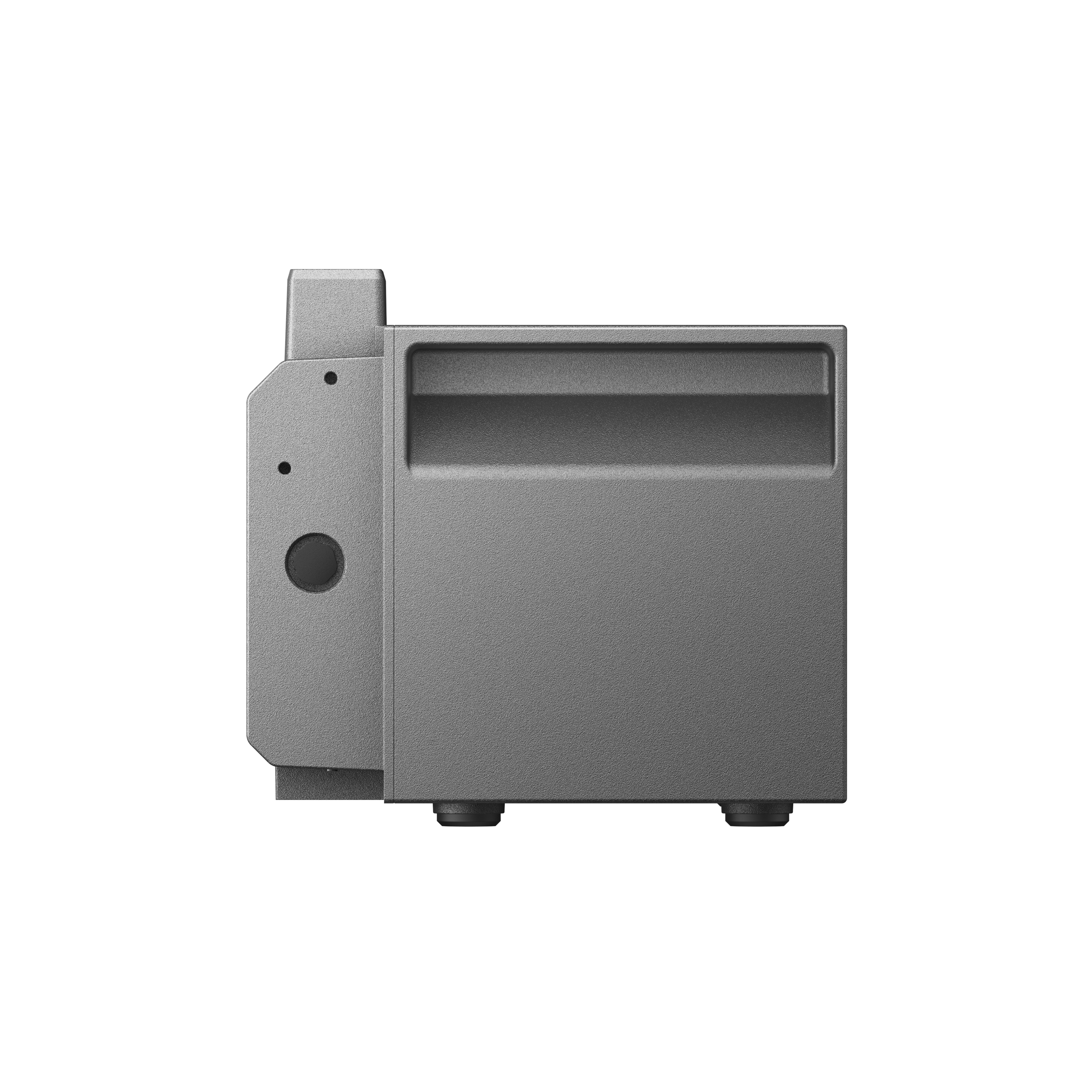 Widok z boku szarego urządzenia z zaokrąglonymi krawędziami. Jest prostokątne i ma małe nóżki.