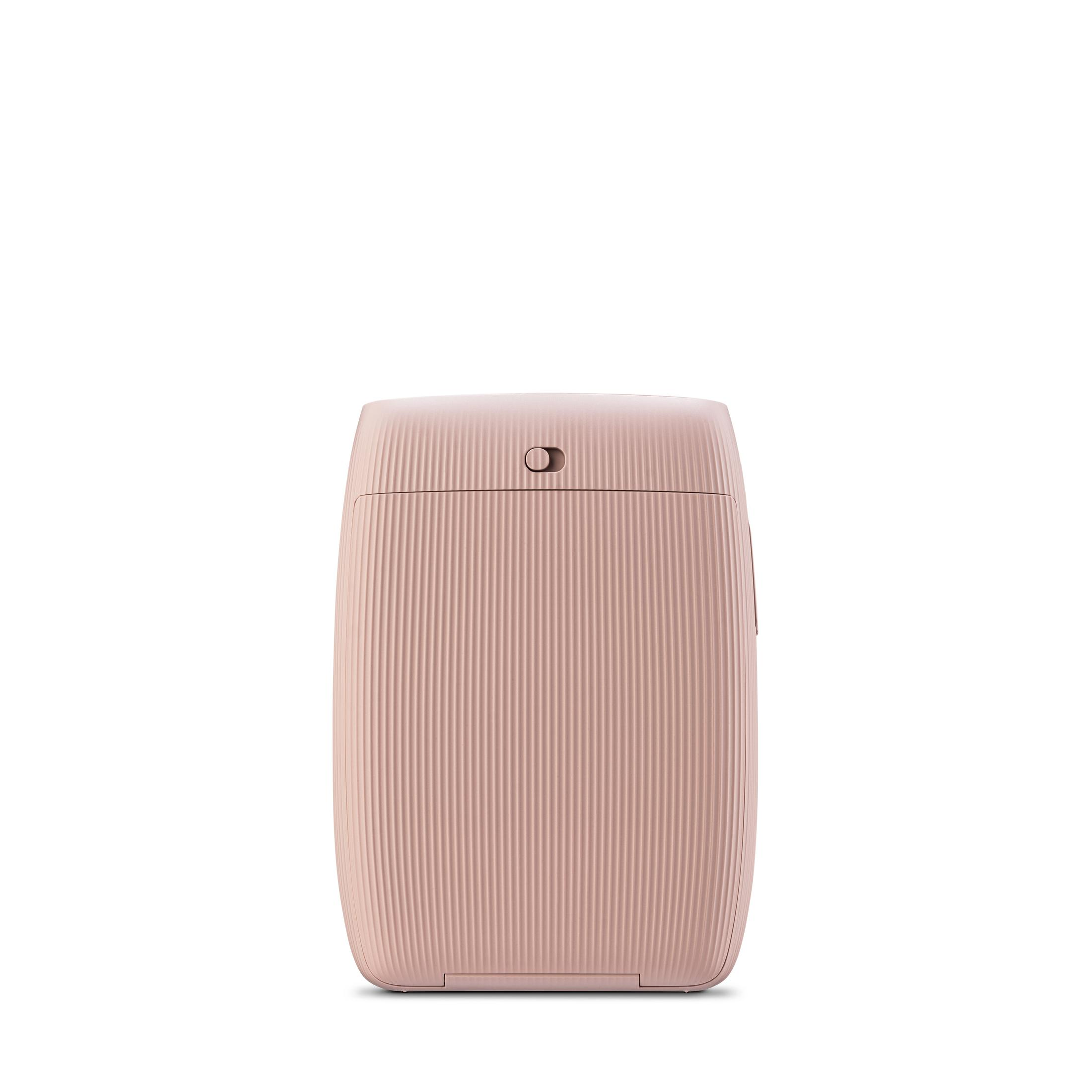 Una stampante rosa con creste verticali è centrata su uno sfondo bianco.