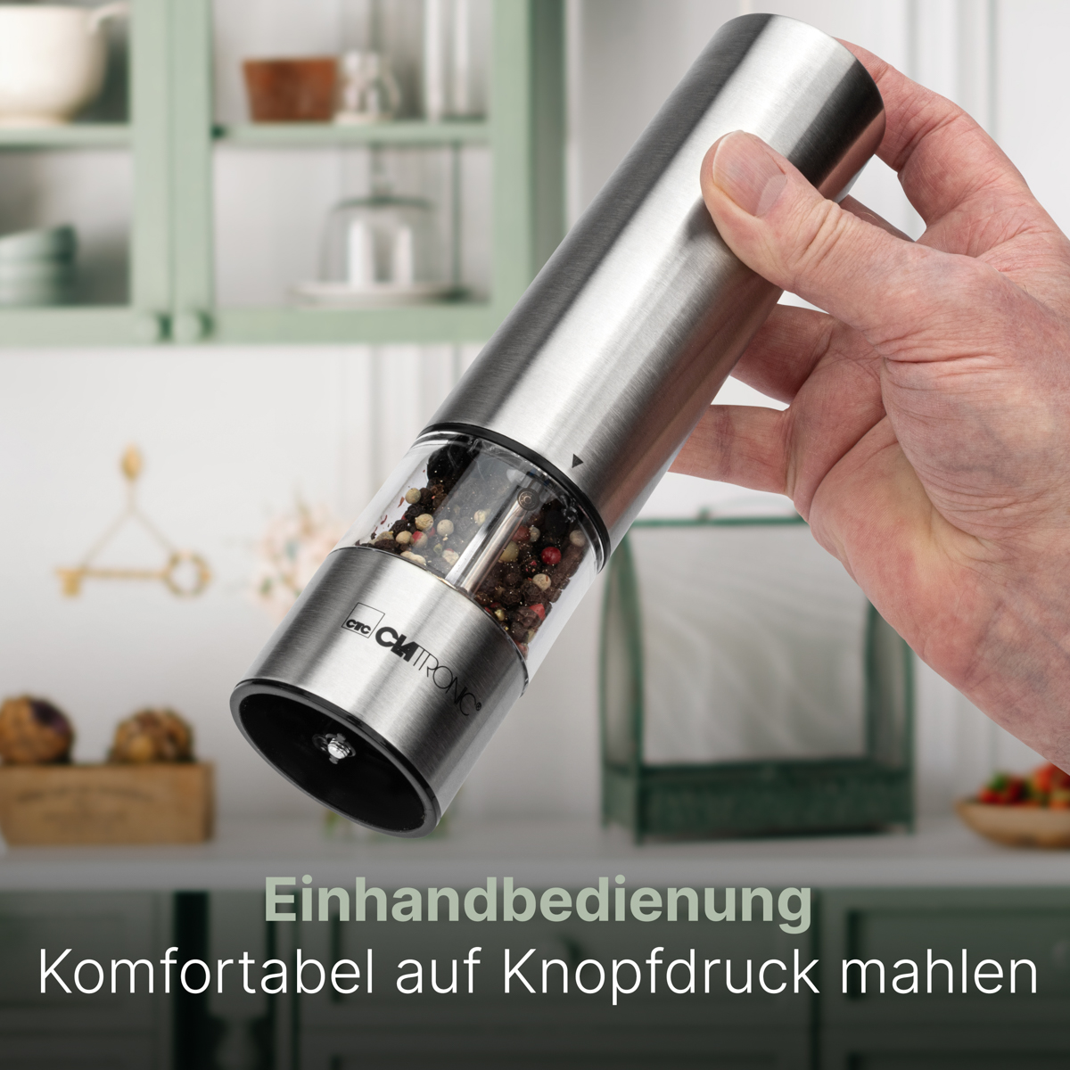 Ręka trzymająca elektryczny młynek do pieprzu, tekst: łatwa obsługa jedną ręką.