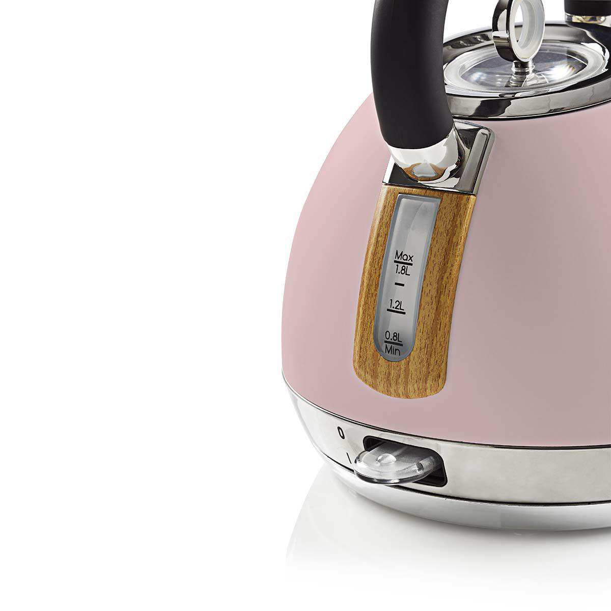 Bollitore elettrico rosa con dettagli in legno, base cromata e manico nero.