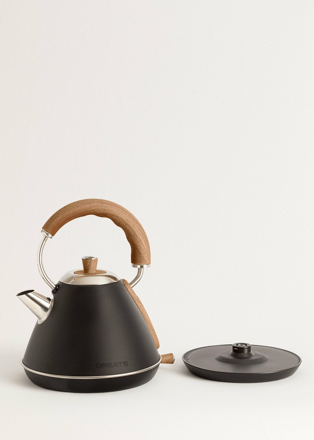 Hervidor eléctrico negro con asa y tapa de madera. También se muestra la base.