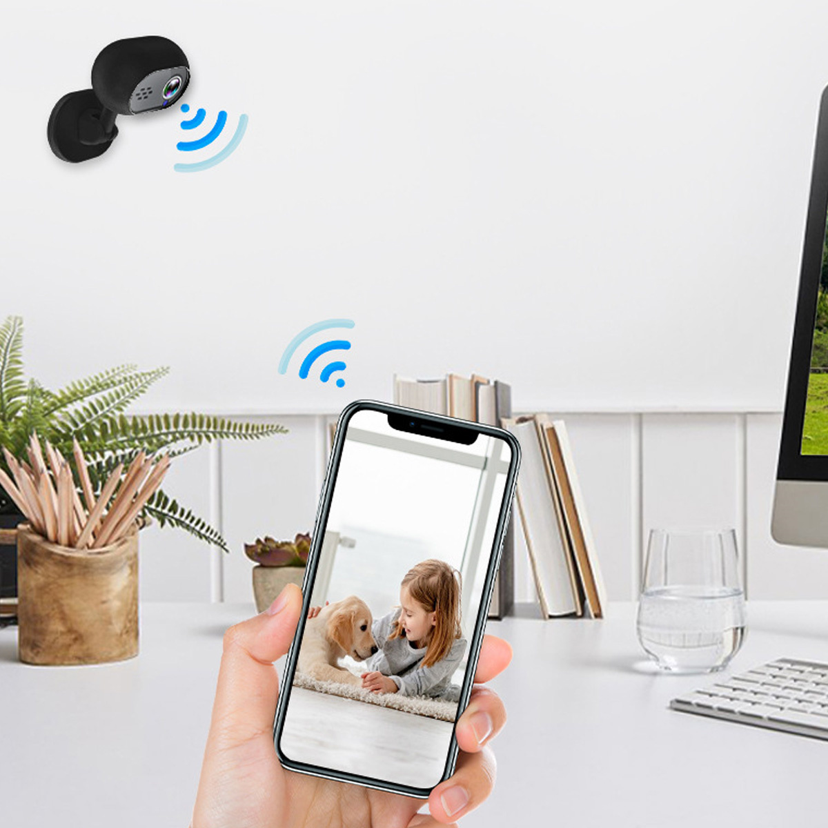 Telefon zeigt Mädchen und Welpen, Überwachungskamera oben.
